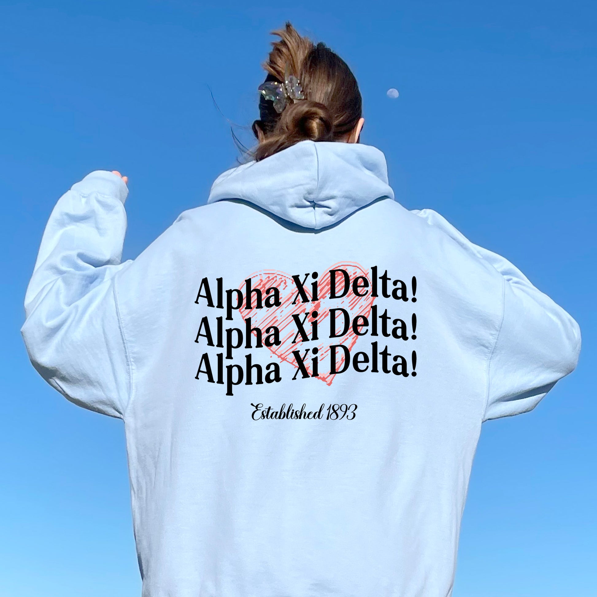 a woman wearing a white hoodie with a heart on it