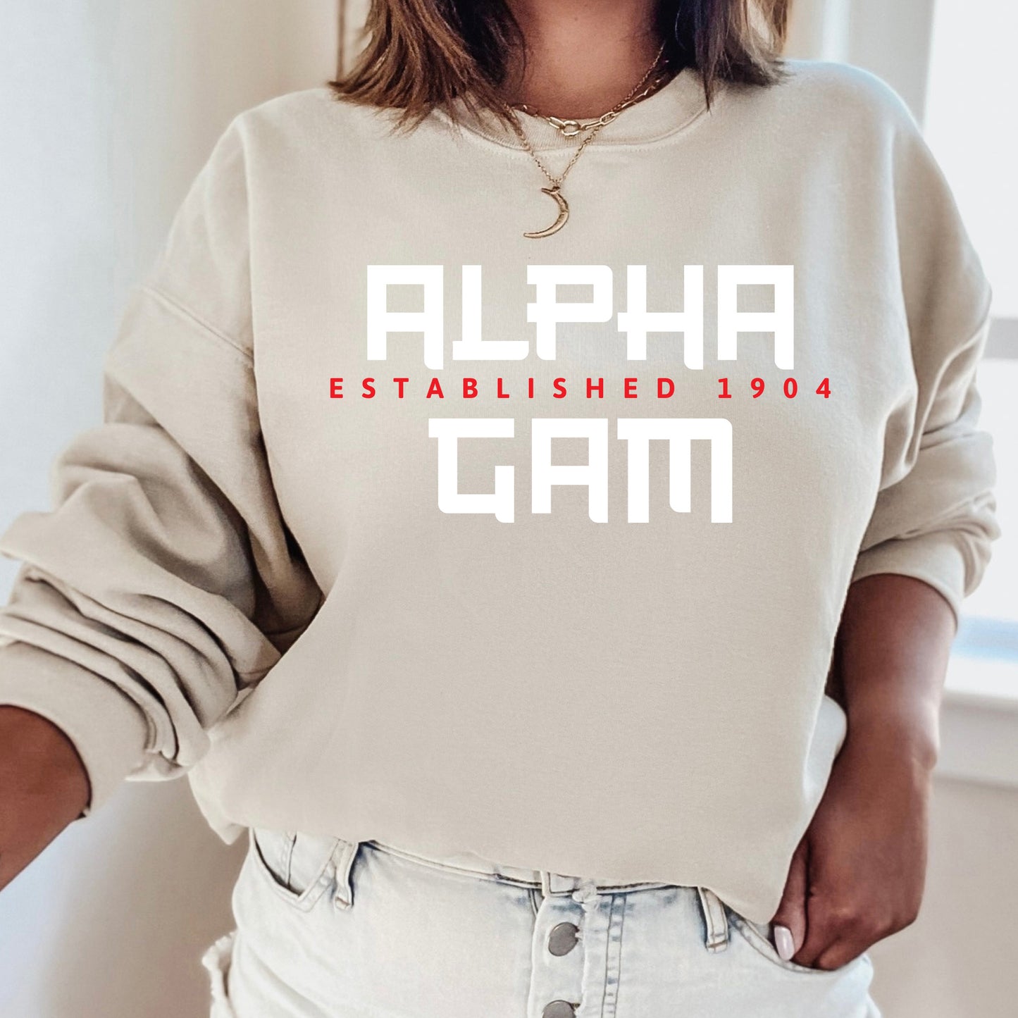 a woman wearing a sweatshirt that says alpha established 1994
