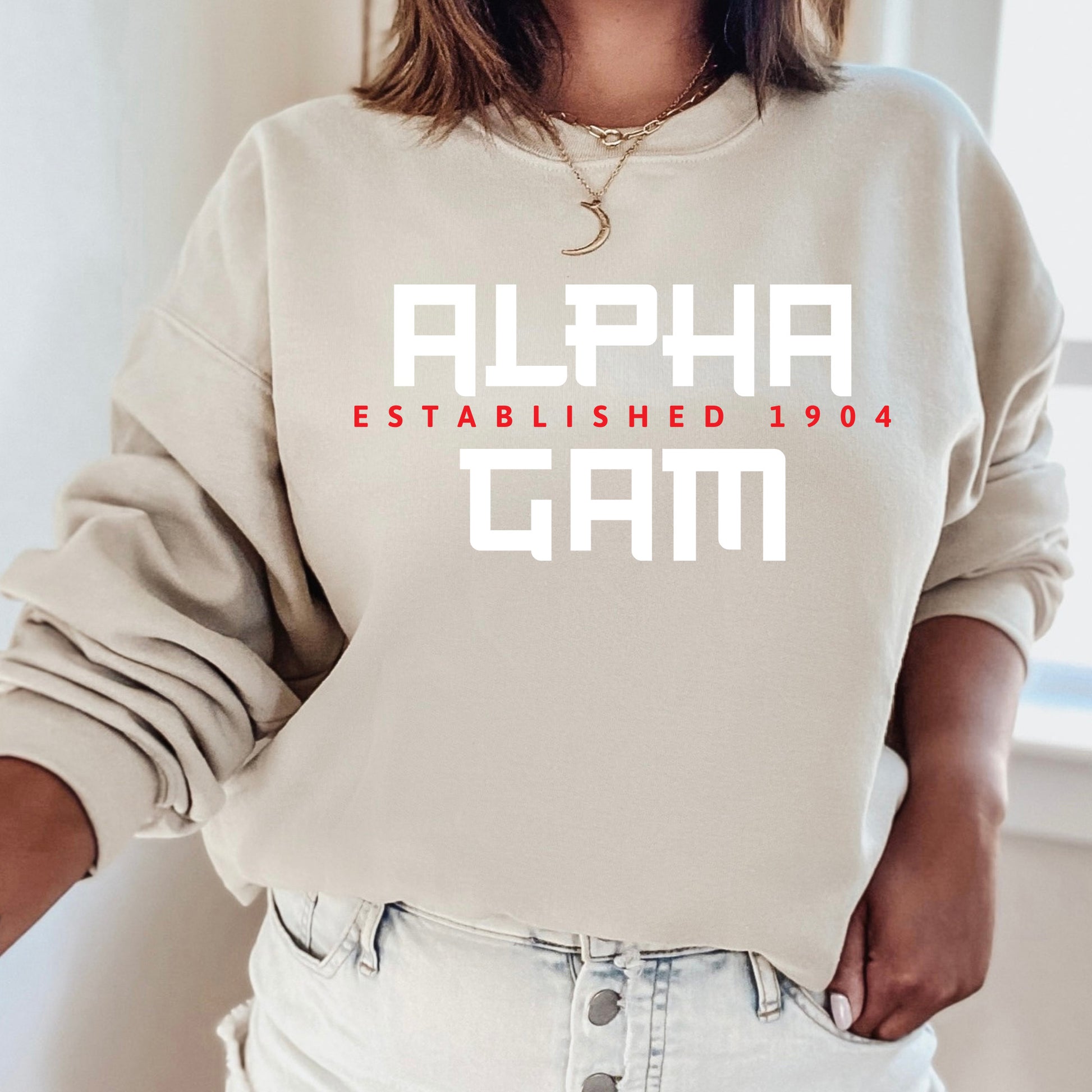 a woman wearing a sweatshirt that says alpha established 1994