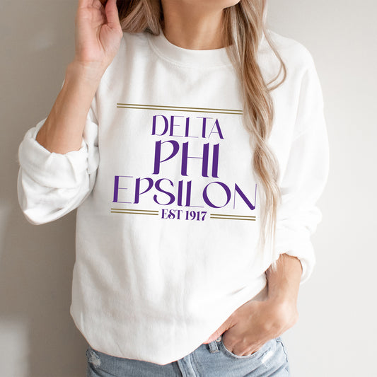 a woman wearing a white sweatshirt with purple lettering