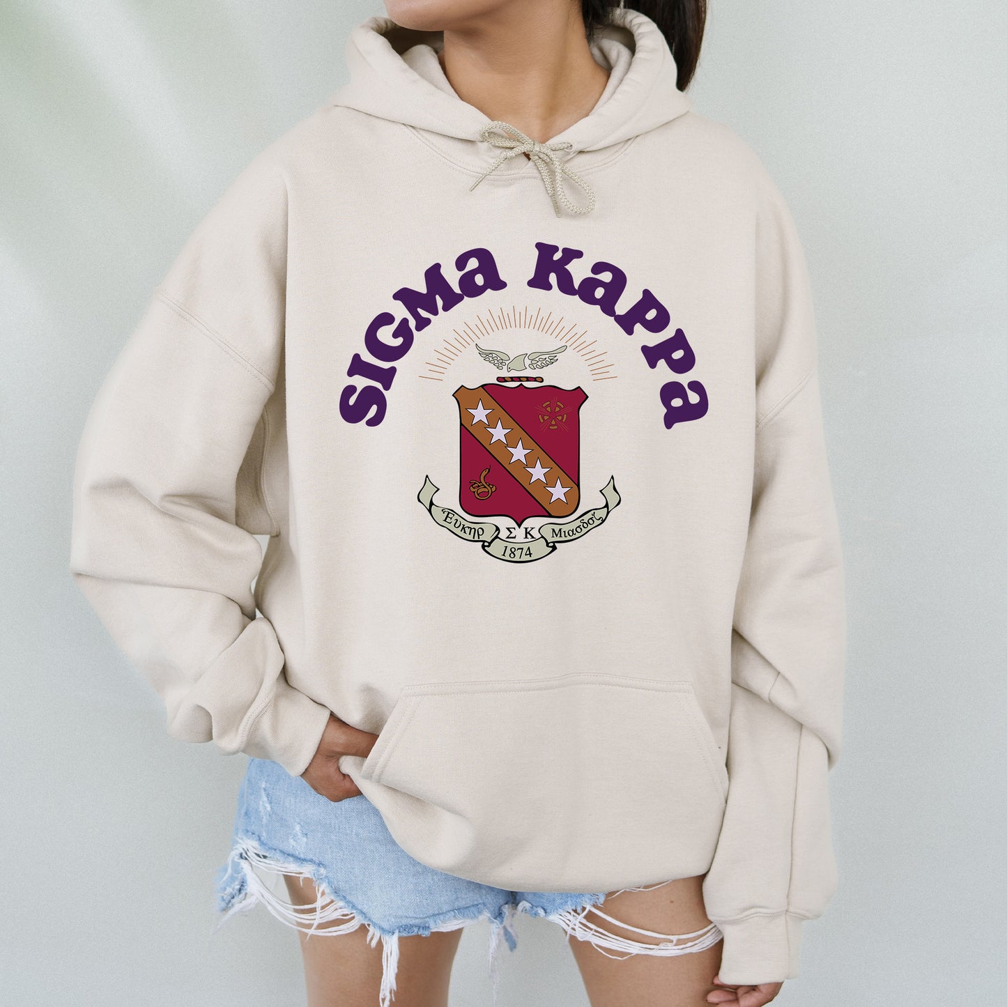 a woman wearing a sweatshirt with the words stigmaa kapp on it