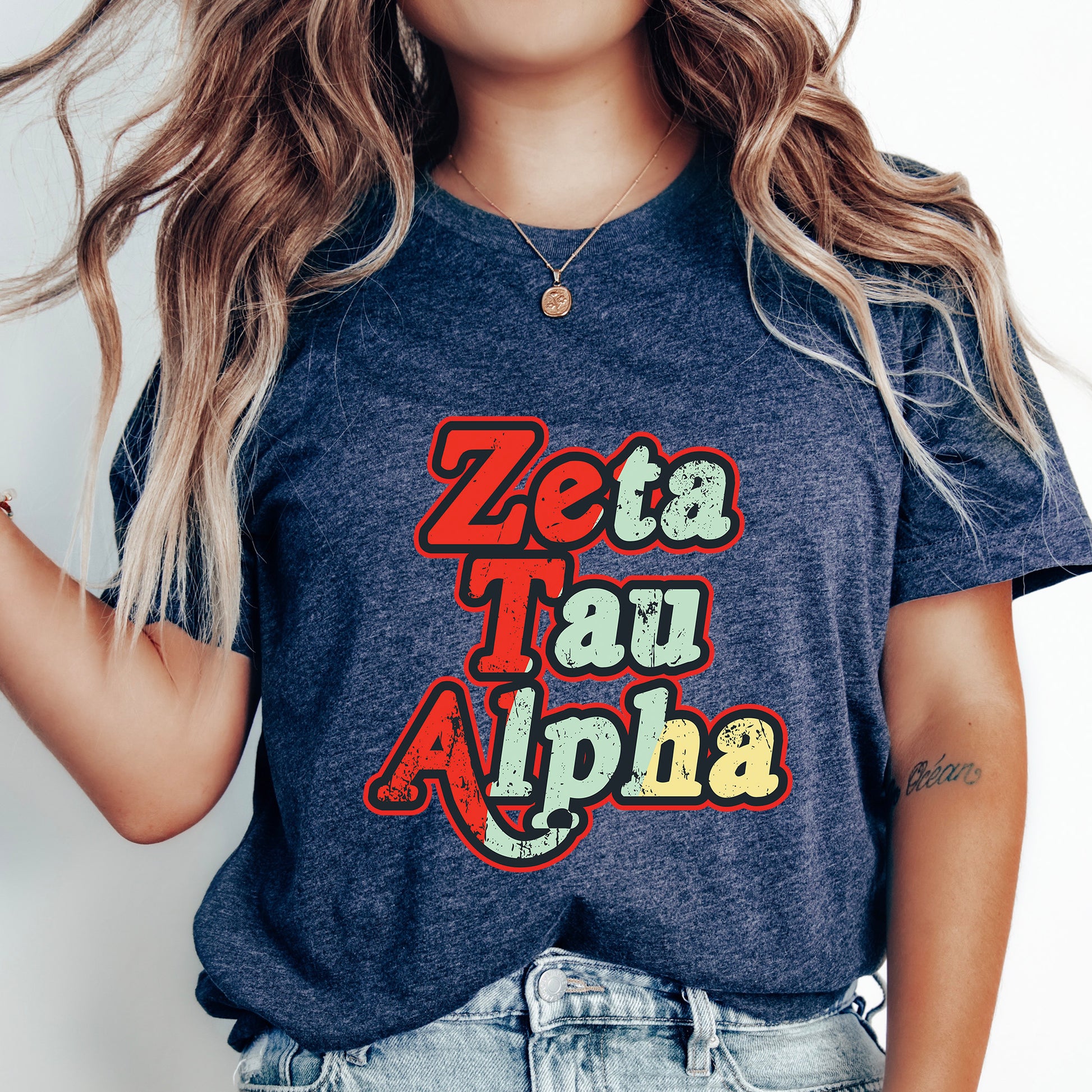 a woman wearing a t - shirt that says zeta tau alpha