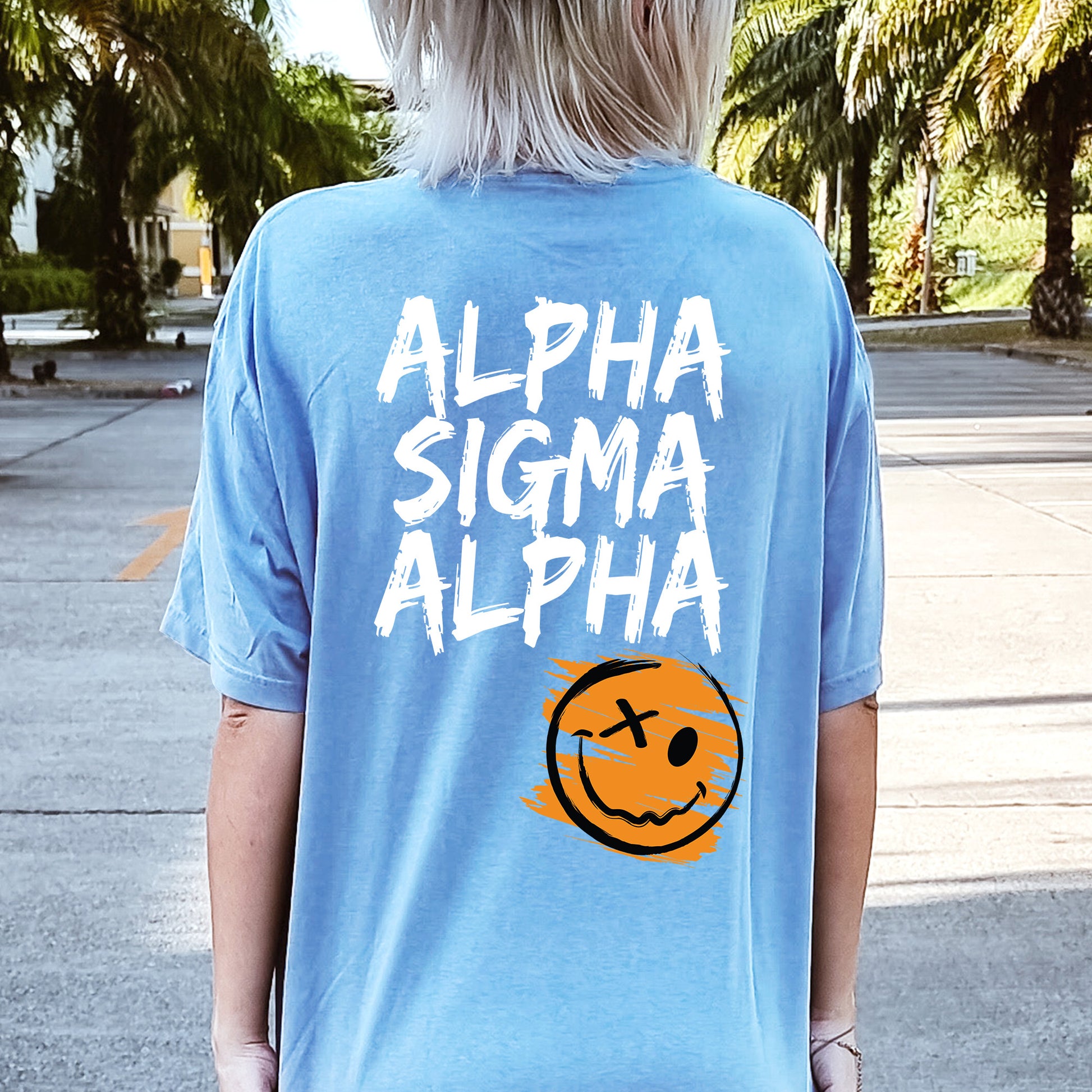 a person wearing a blue shirt with a smiley face on it