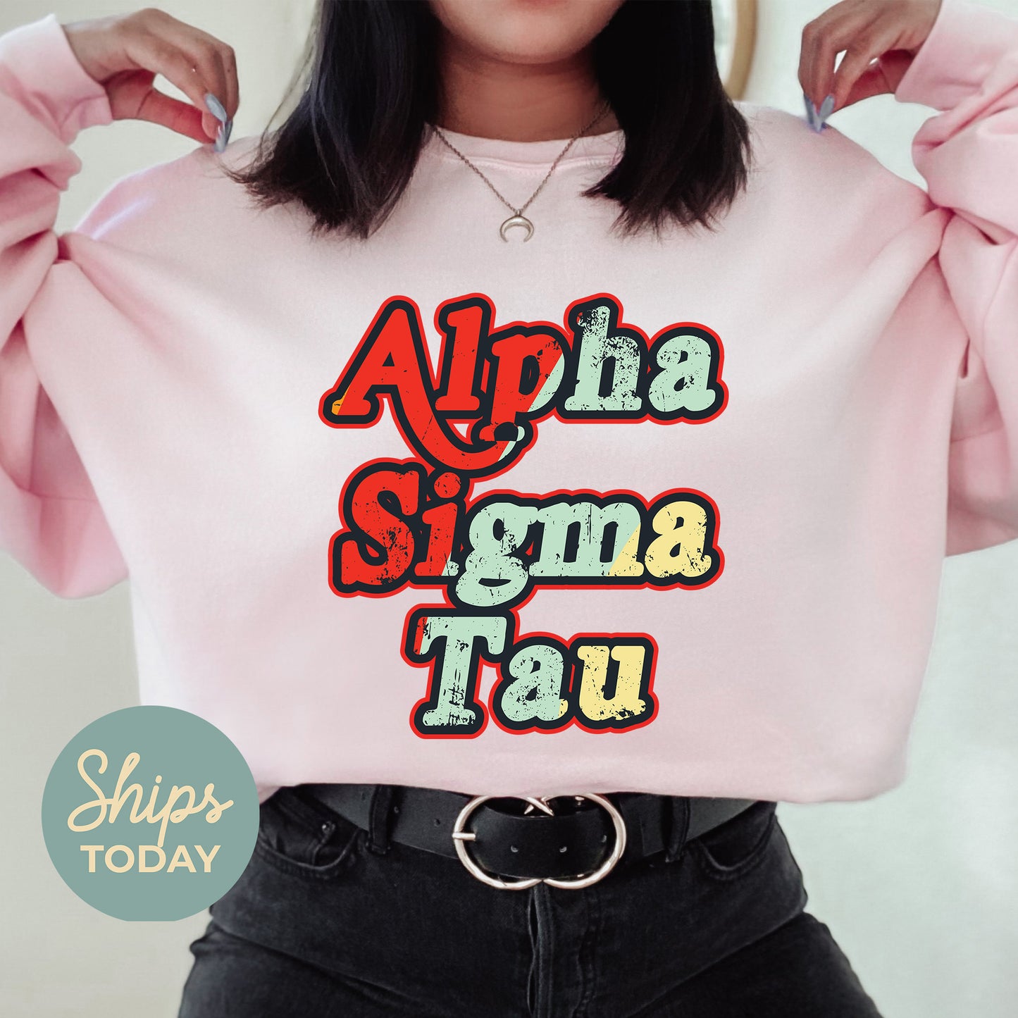 a woman wearing a pink sweatshirt with the words aloha stigma tau on it