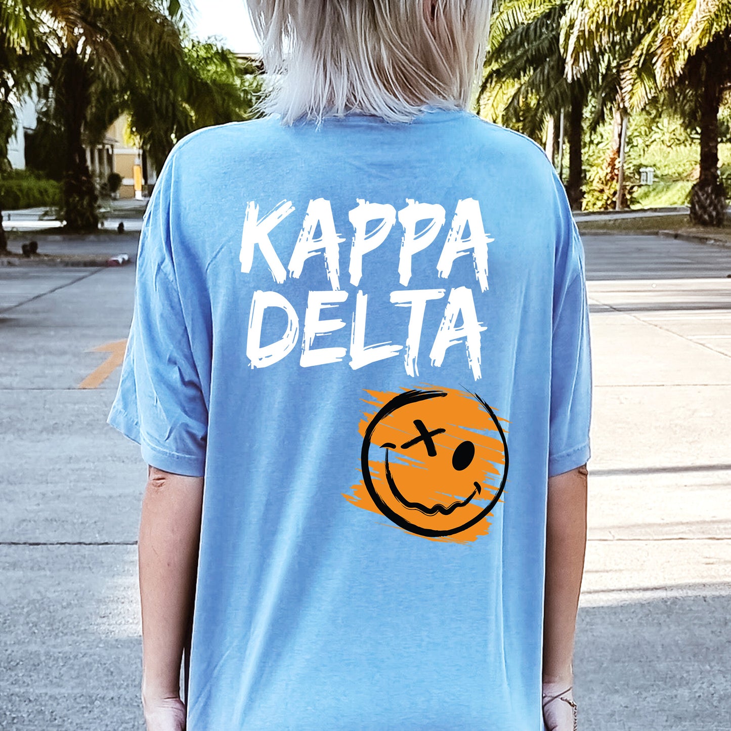 a person wearing a blue shirt that says kappa delta