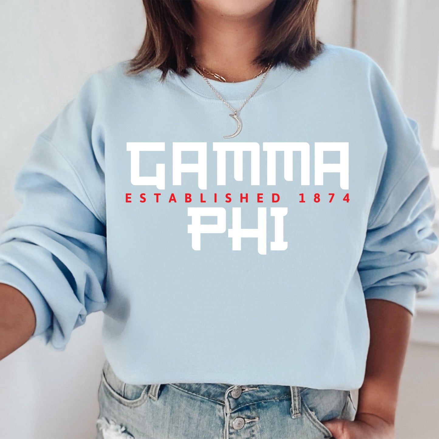 a woman wearing a blue sweatshirt that says camma established 1974