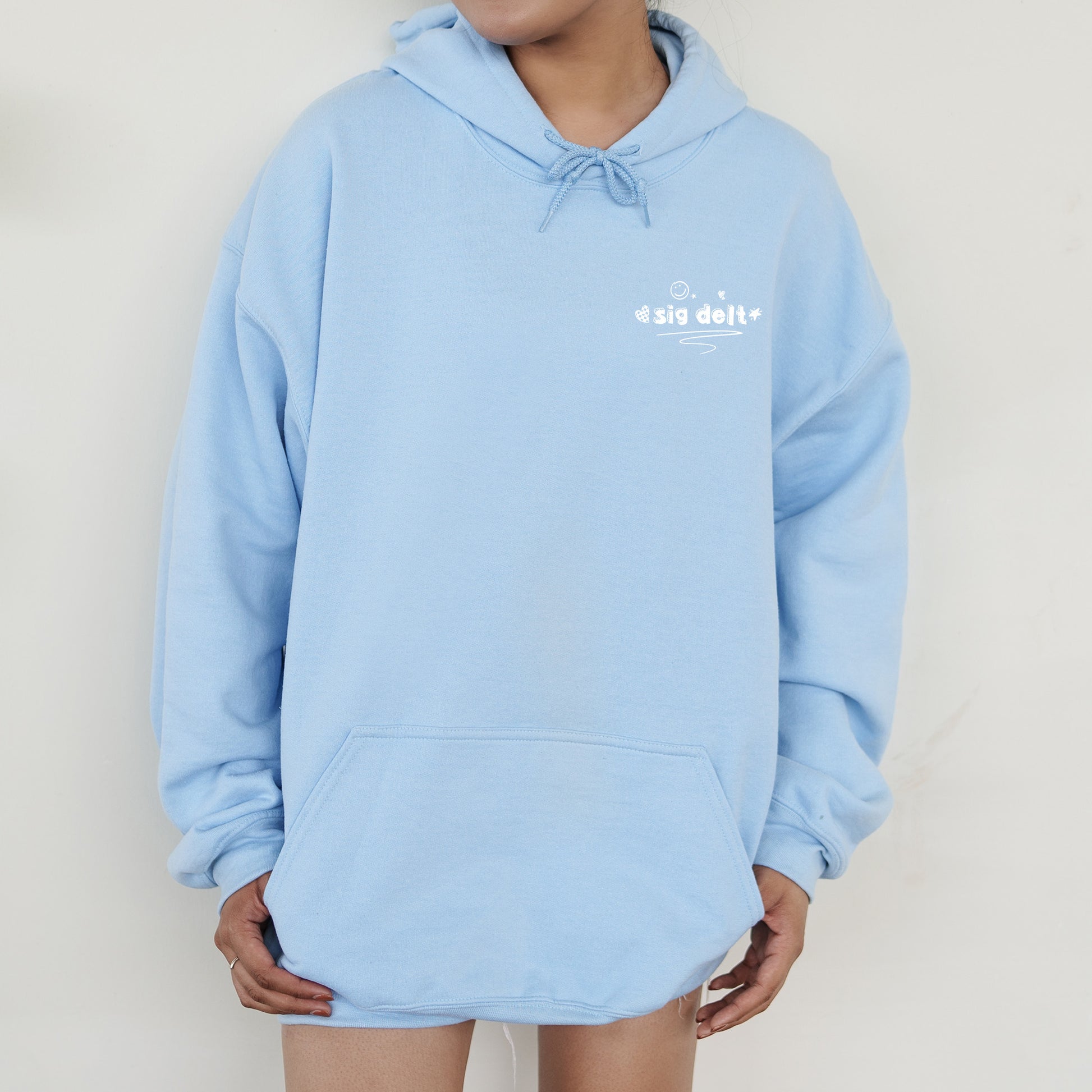 a person wearing a blue hoodie with white writing on it