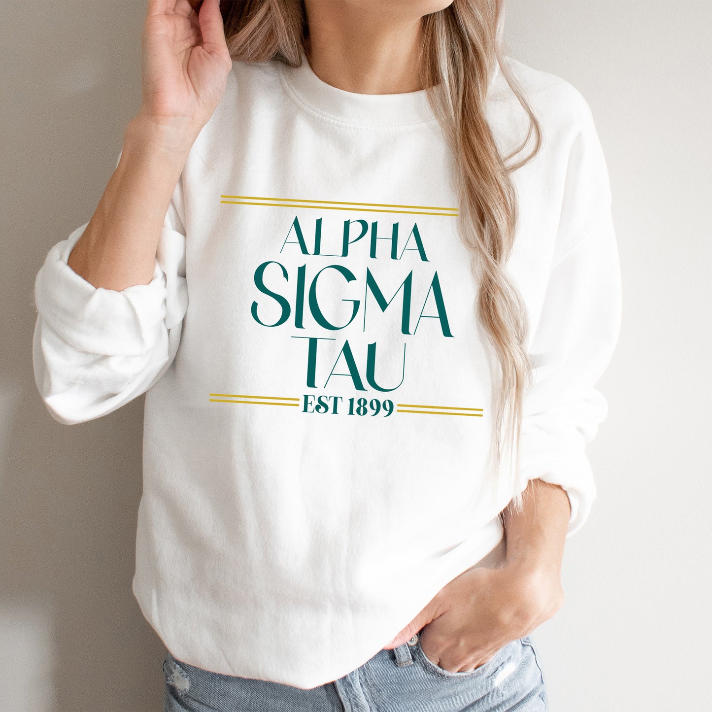 a woman wearing a white sweatshirt with a green logo