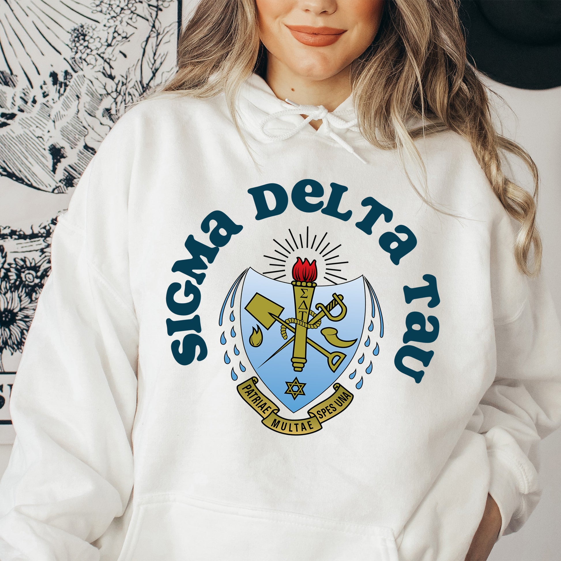 a woman wearing a white hoodie with the seal of the state of north carolina