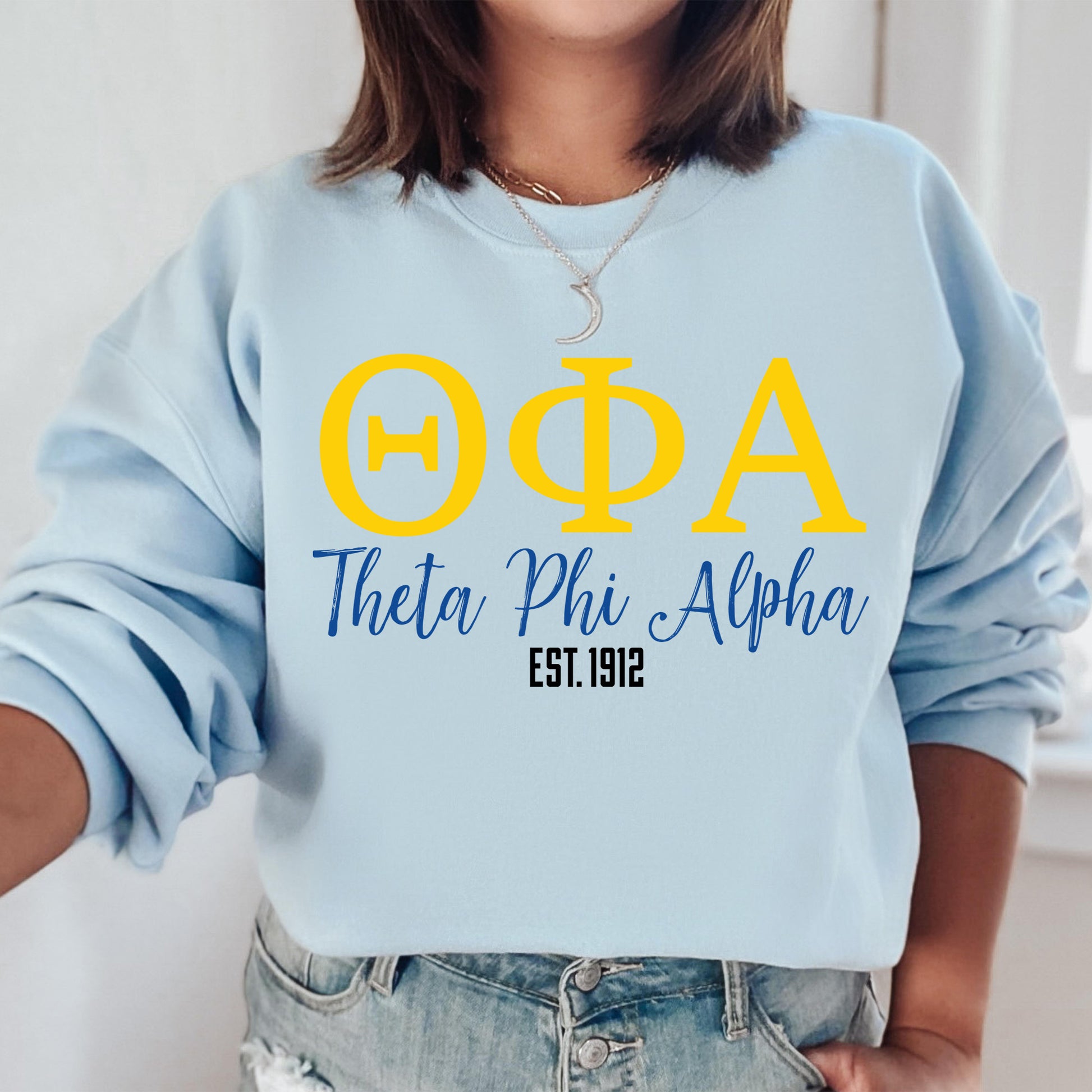 a woman wearing a blue sweatshirt with yellow letters on it