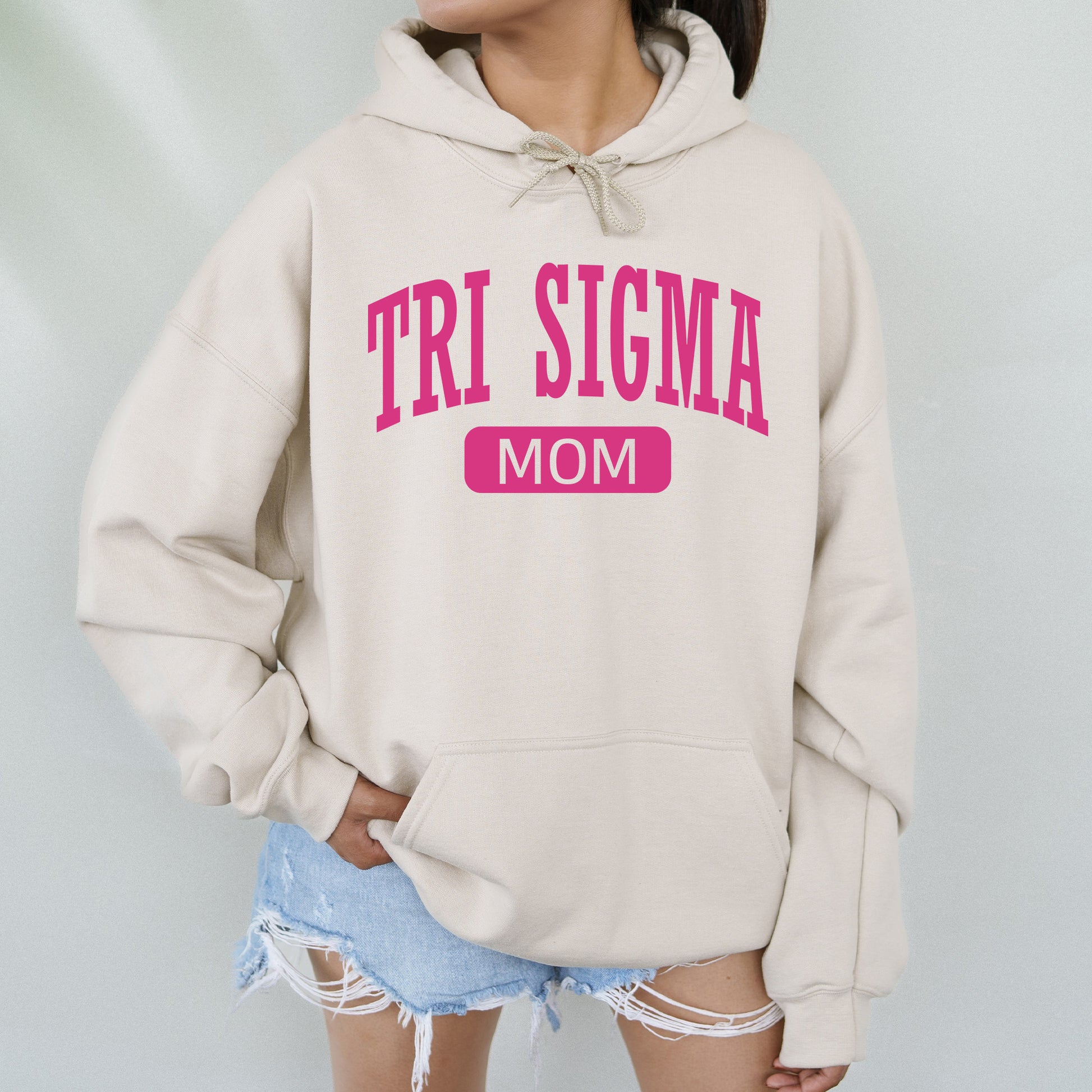 a woman wearing a sweatshirt that says tri stigma mom