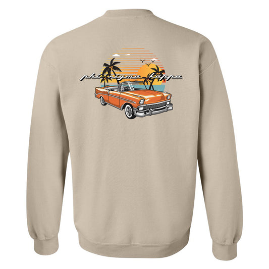 a beige sweatshirt with an orange car and palm trees