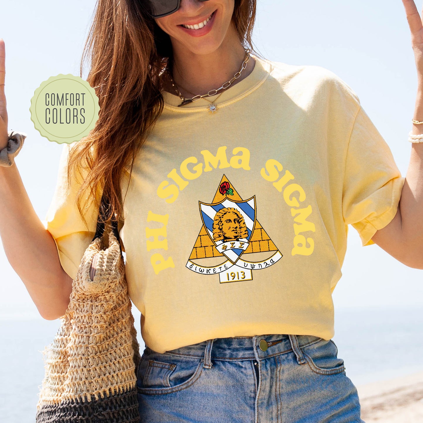 a woman in a yellow shirt is holding a purse