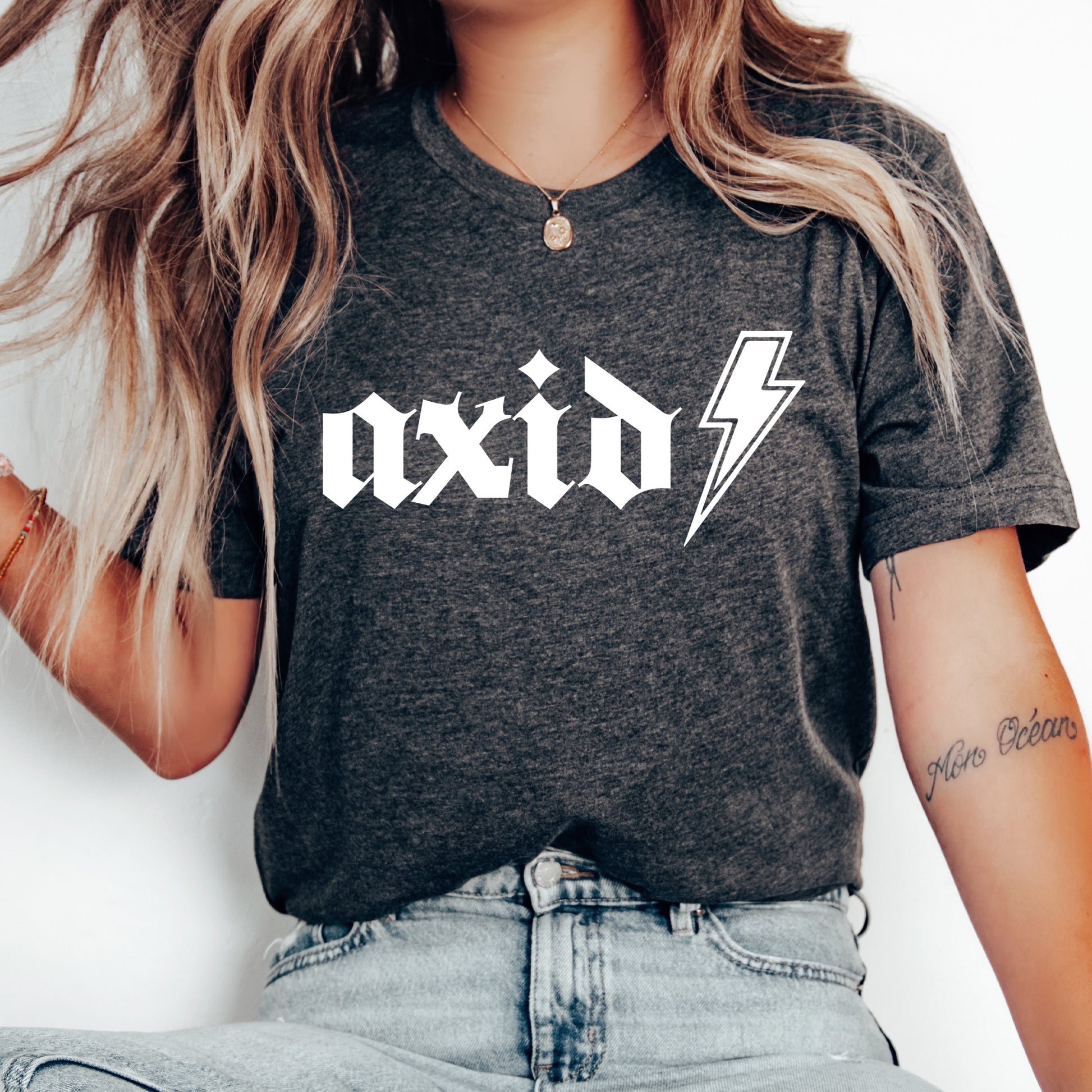 a woman wearing a black shirt with a lightning bolt on it