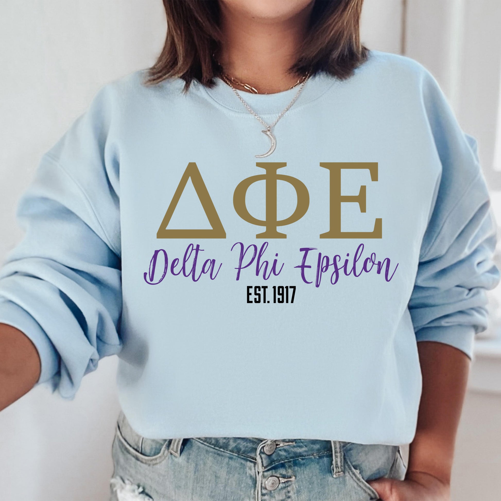 a woman wearing a sweatshirt that says ape delta phi - epsion