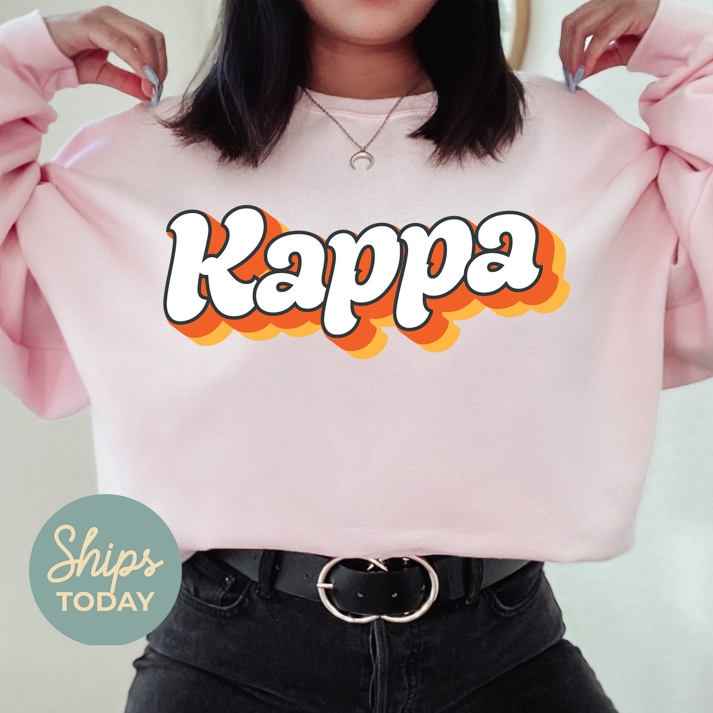 a woman wearing a pink sweatshirt with the word kapp on it