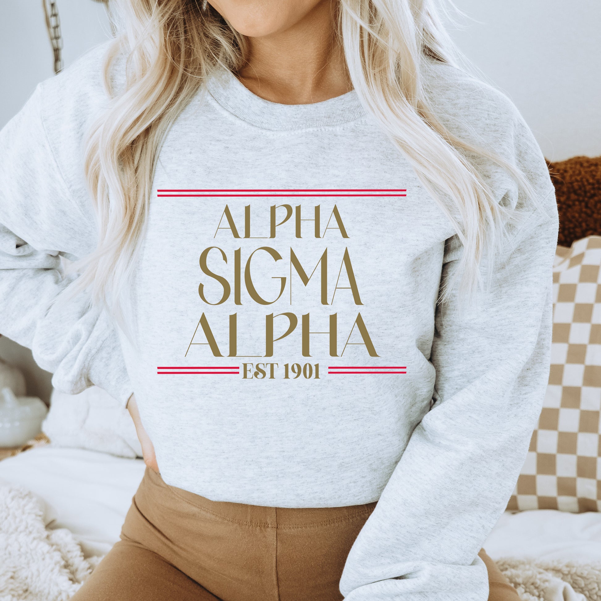 a woman wearing a sweatshirt that says, alpha sigma alpha est