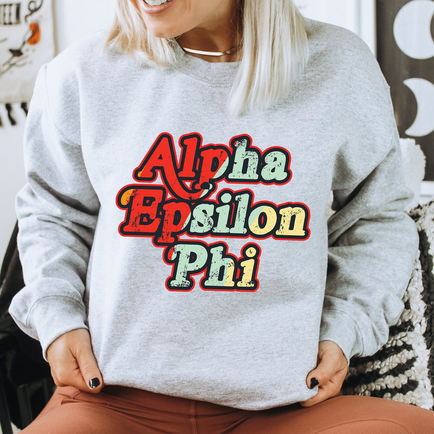 a woman sitting on a chair wearing a sweatshirt with the words aloha eps