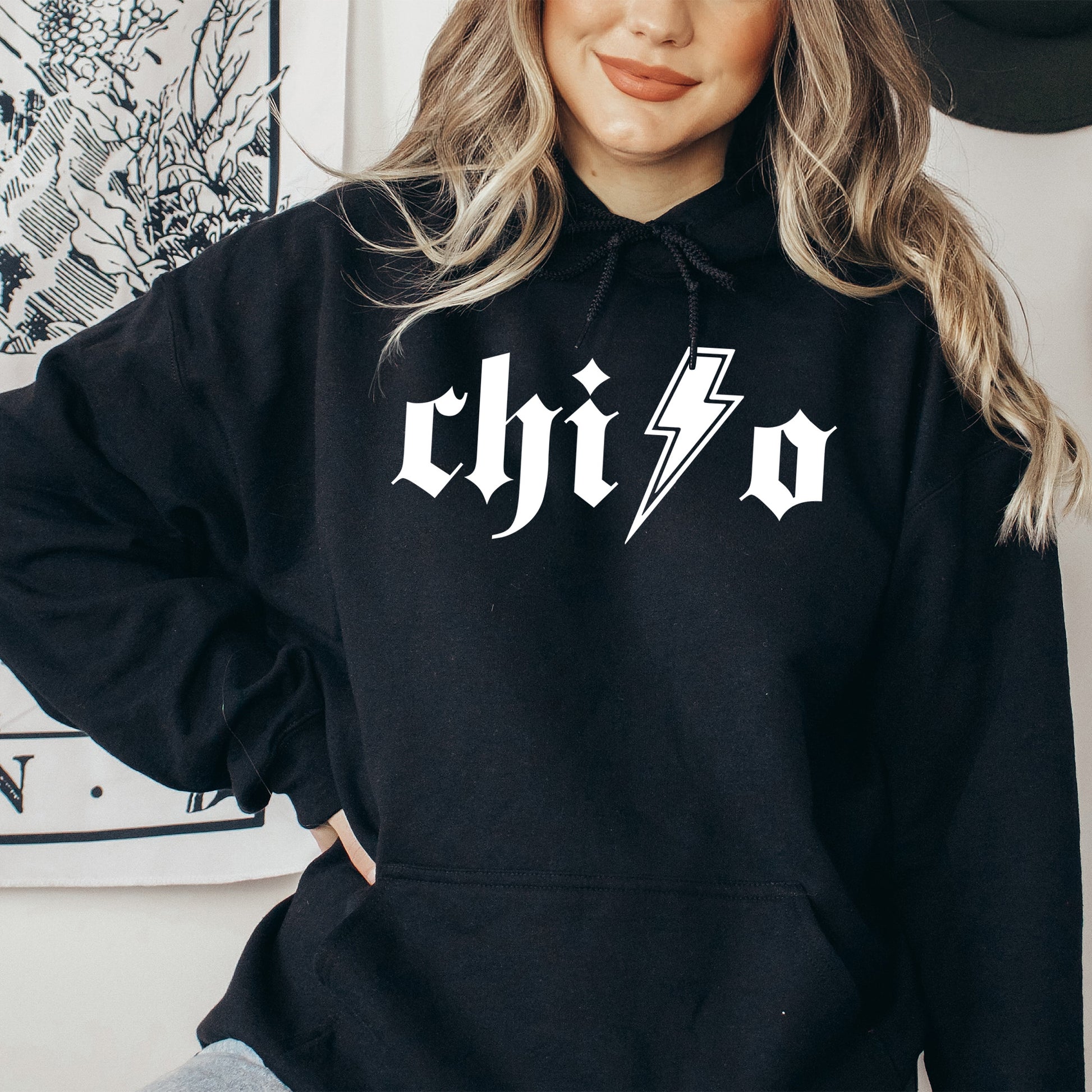 a woman wearing a black hoodie with a lightning bolt on it