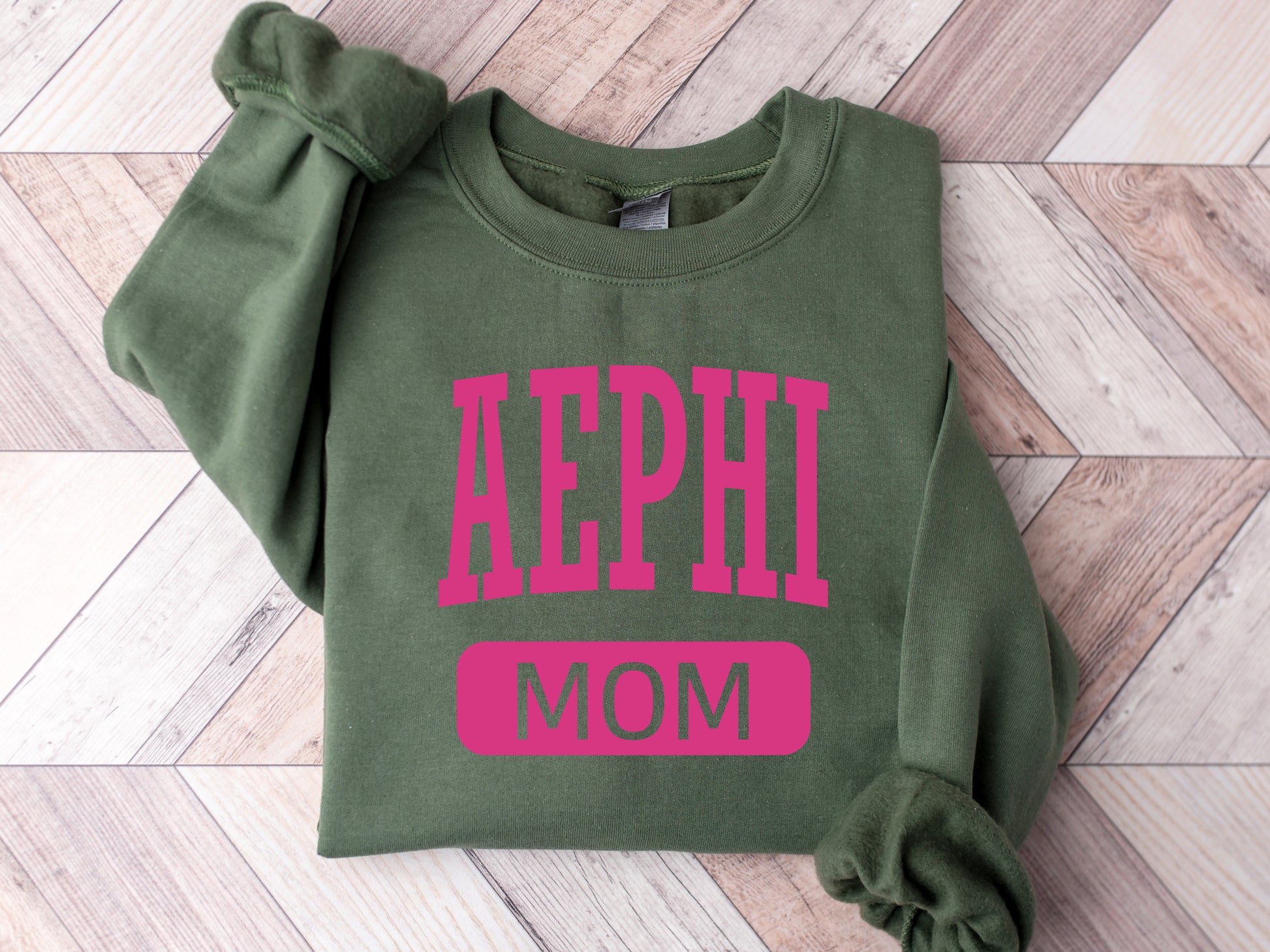 a green sweatshirt with the word aephi mom printed on it