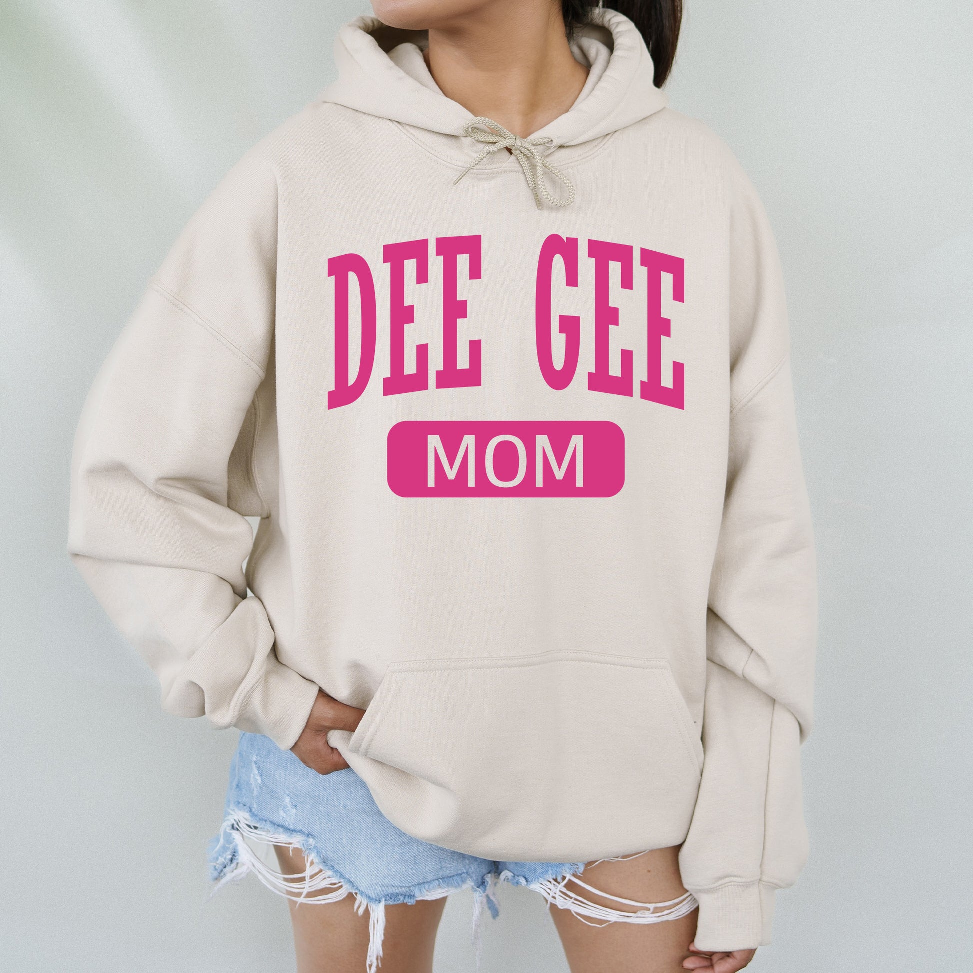 a woman wearing a sweatshirt that says die gee mom
