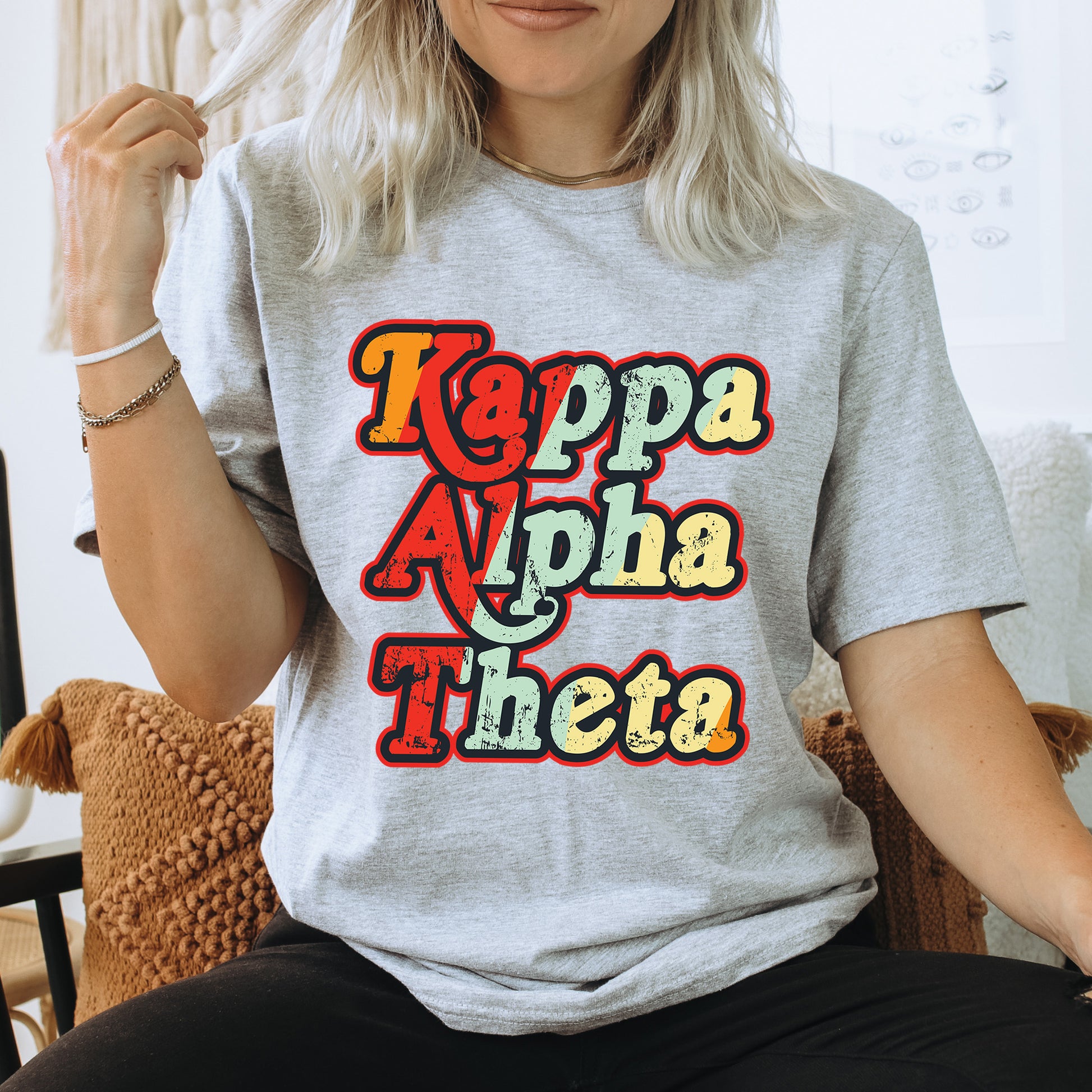 a woman sitting on a chair wearing a t - shirt that says kappa