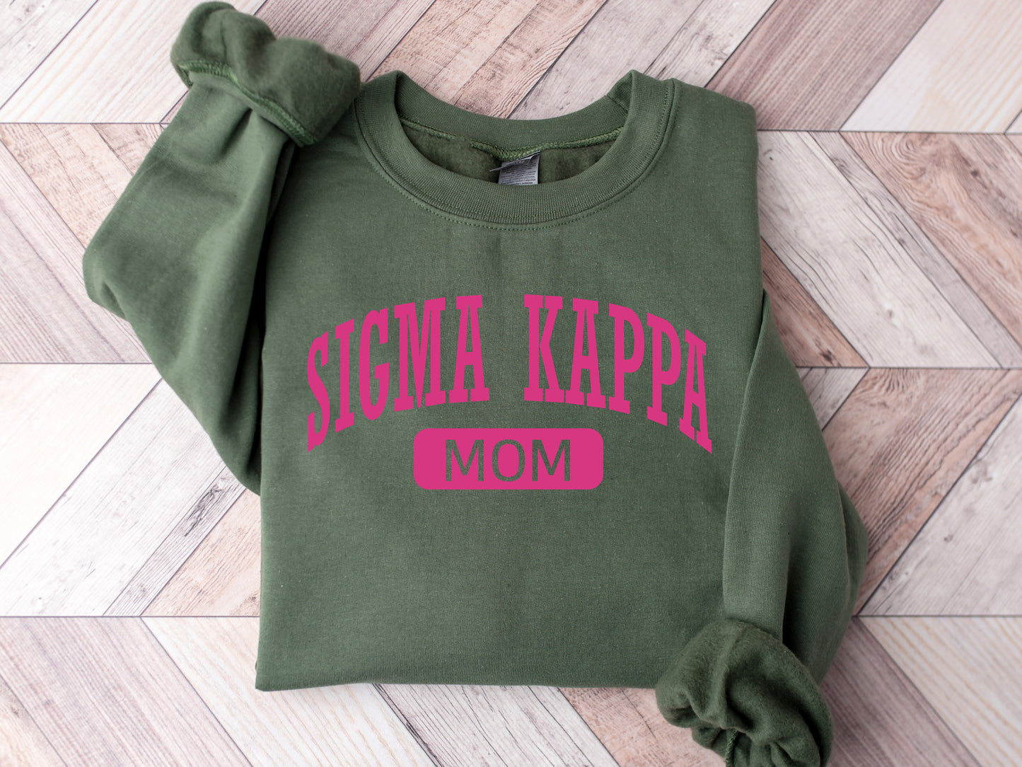 a green sweatshirt with pink lettering on it