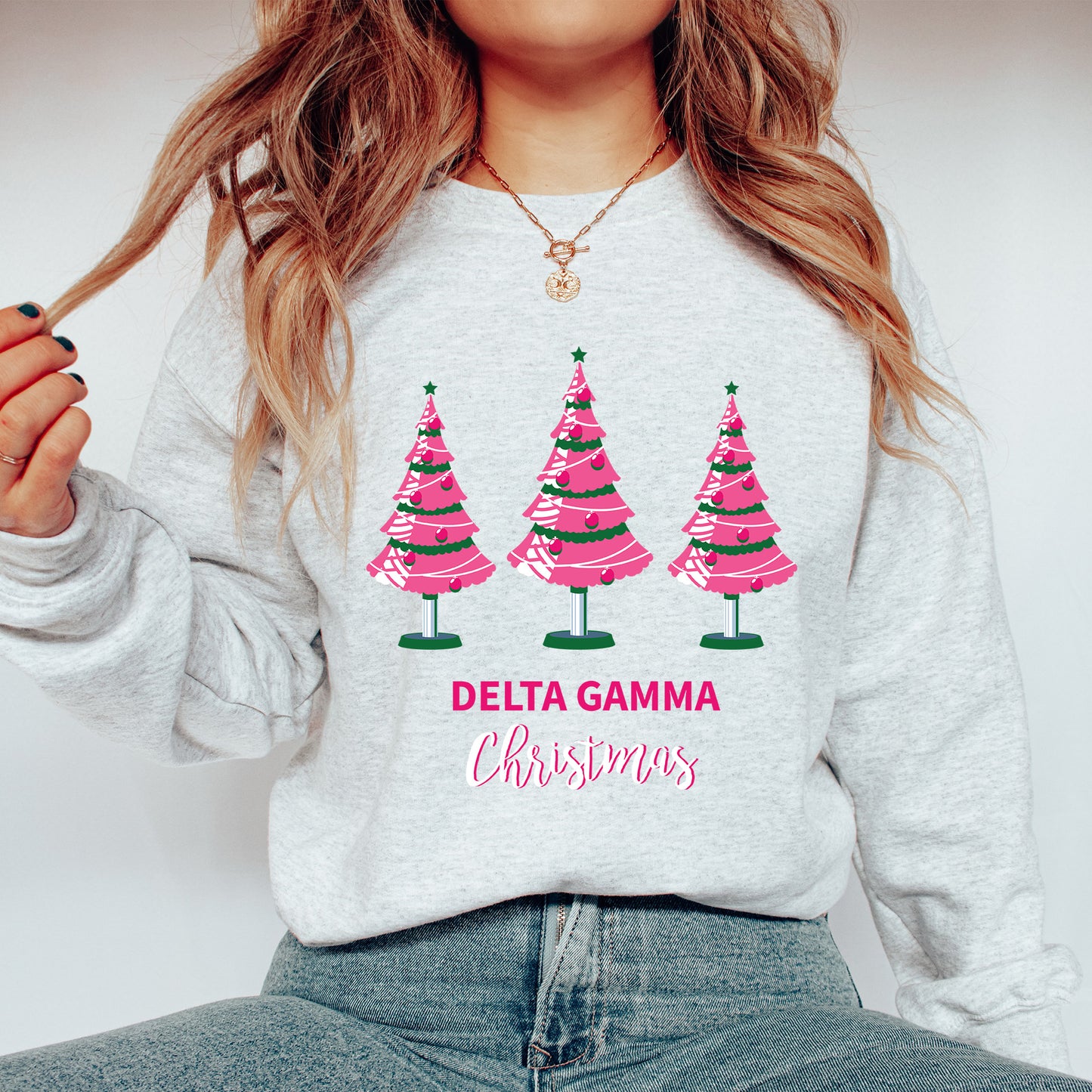 a woman wearing a sweatshirt with christmas trees on it