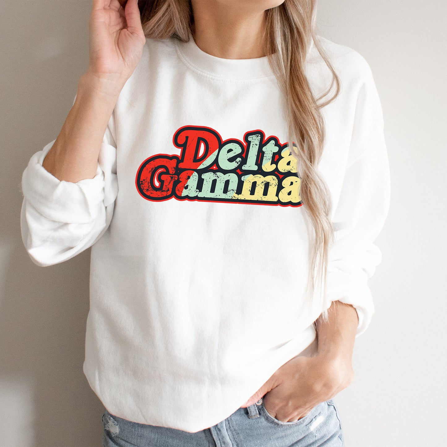 a woman wearing a white sweatshirt with the words delta gama on it