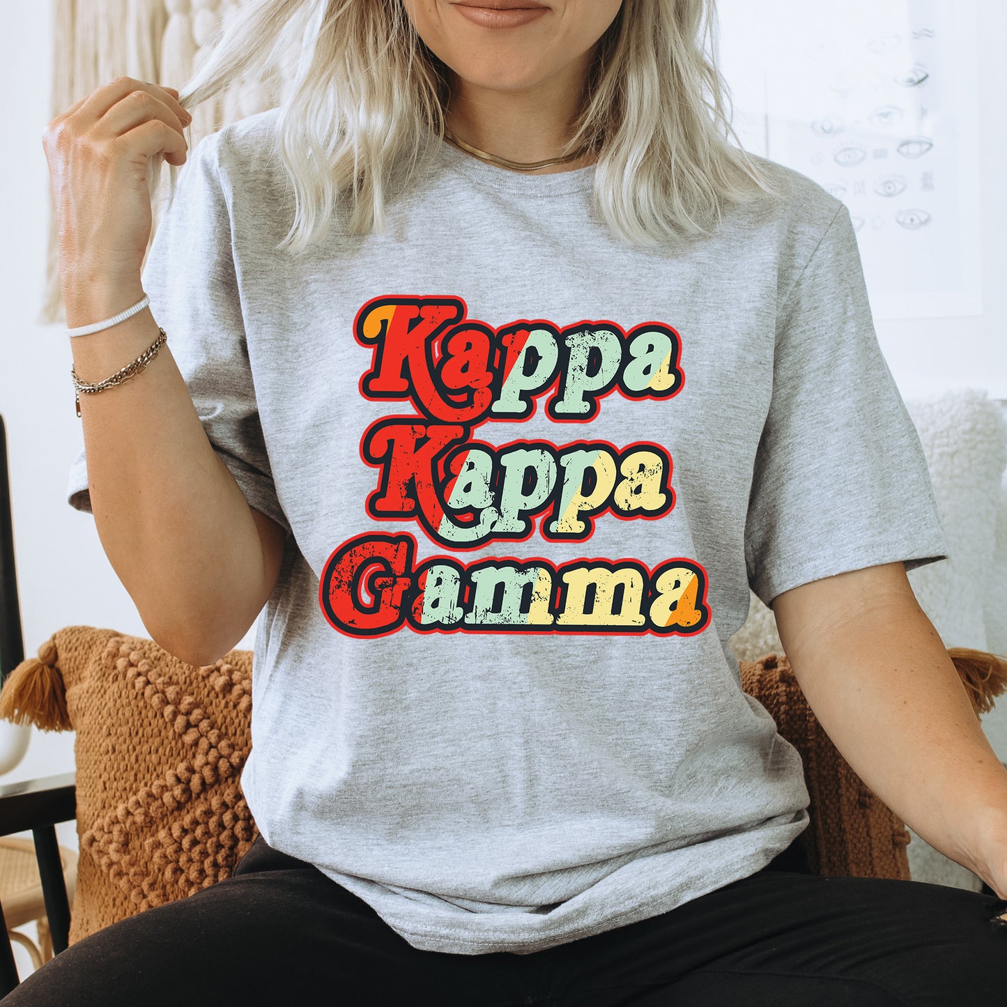 a woman sitting on a chair wearing a t - shirt that says kapa ka
