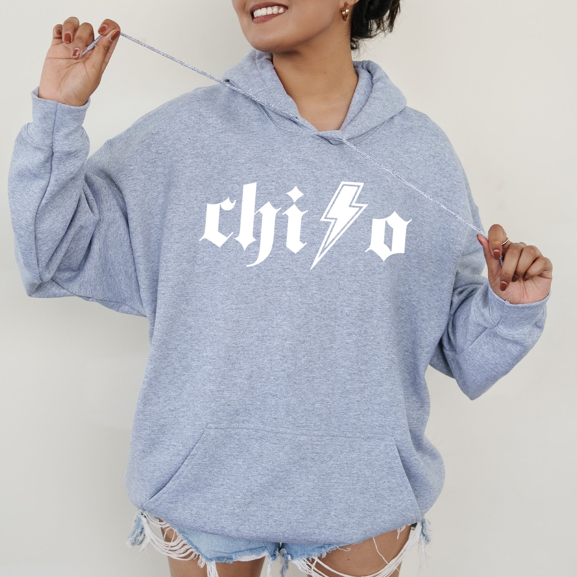 a woman wearing a blue hoodie with a lightning bolt on it