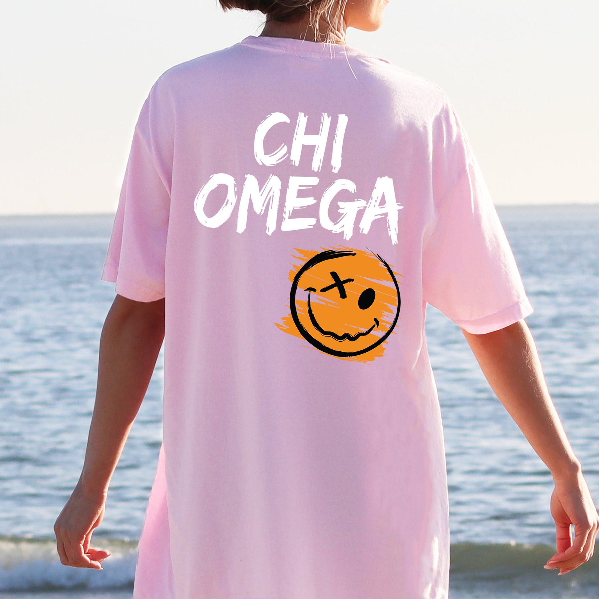 a person wearing a pink shirt with a smiley face on it