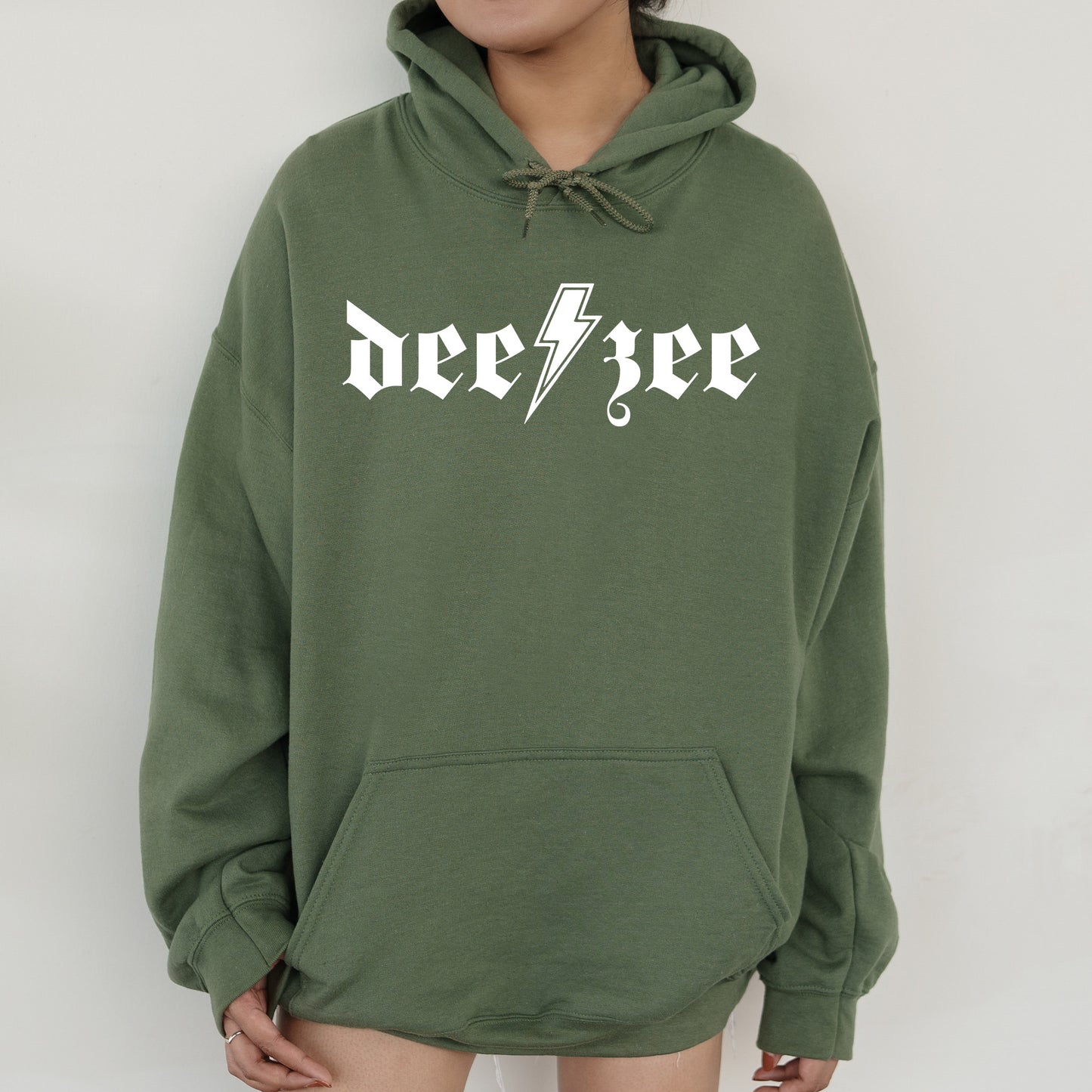 a person wearing a green hoodie with a lightning bolt on it