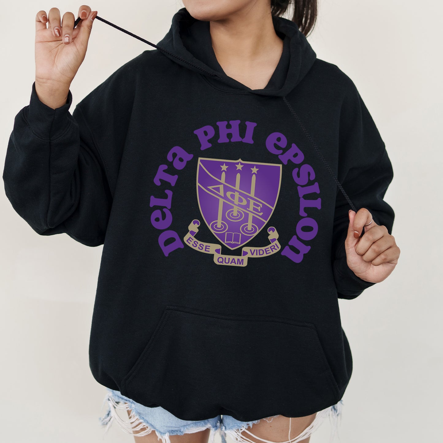a girl wearing a black hoodie with purple letters on it
