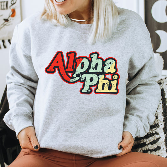 a woman sitting on a chair wearing a sweatshirt that says aloha phi