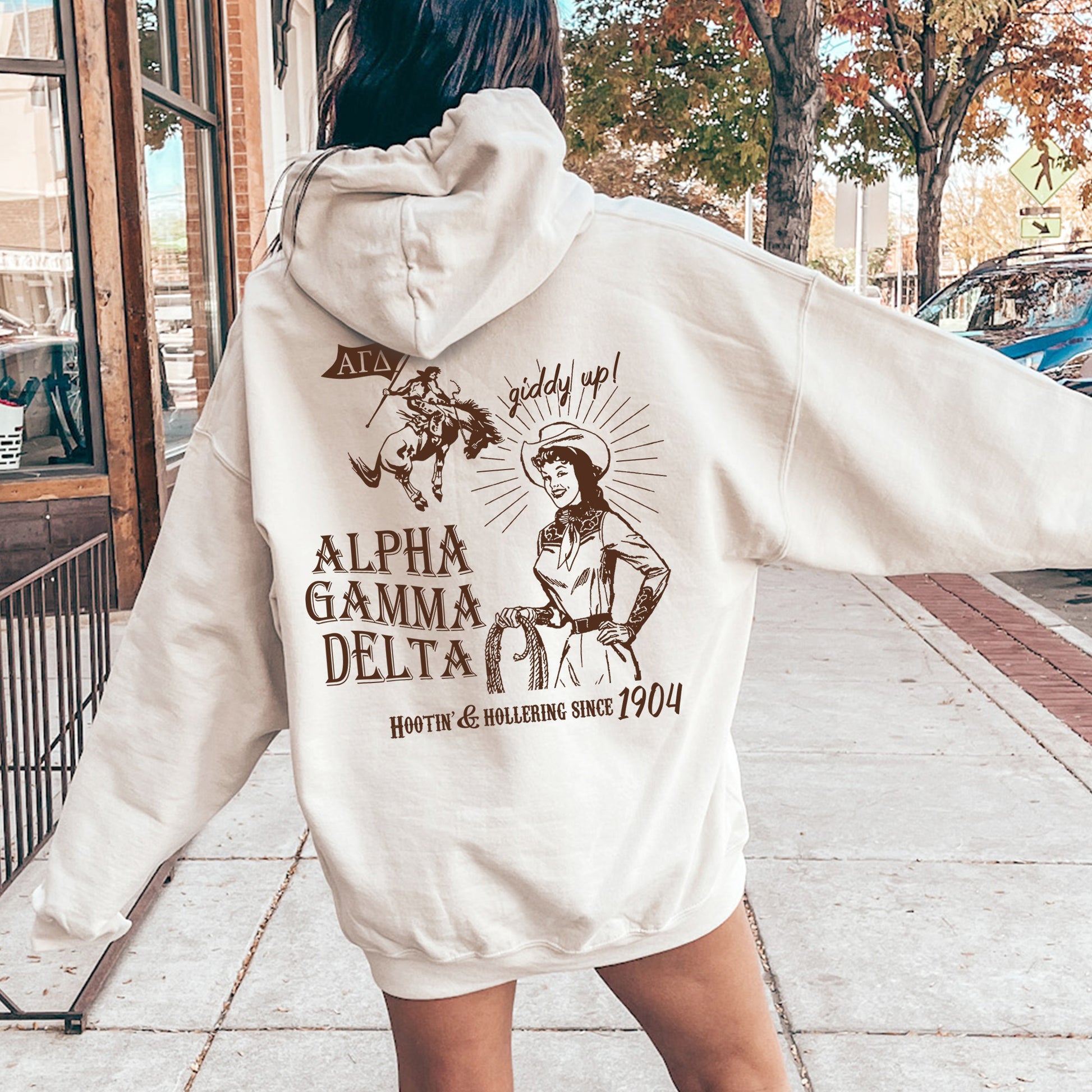 a woman in a white hoodie is walking down the street