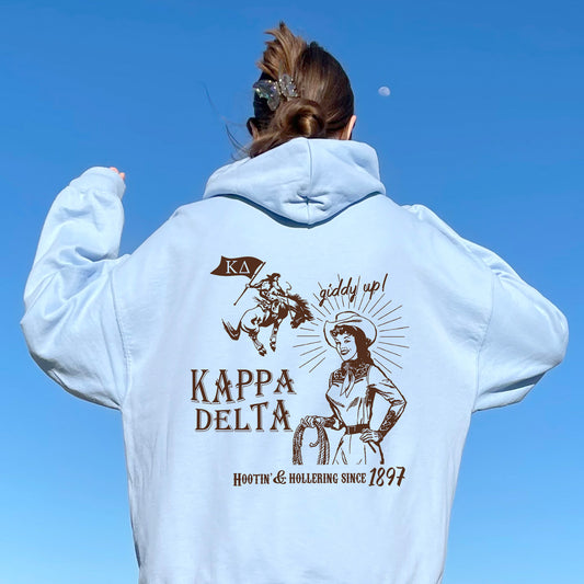 a woman in a white hoodie is flying a kite