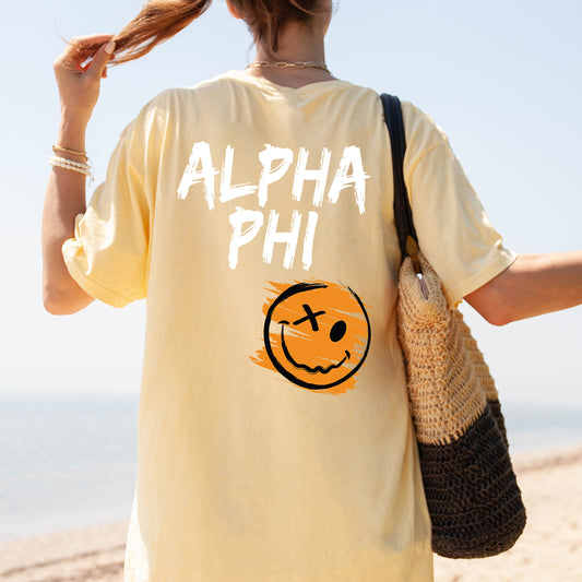 a woman is walking on the beach with a smile on her shirt