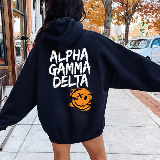 a woman in a black hoodie is walking down the street