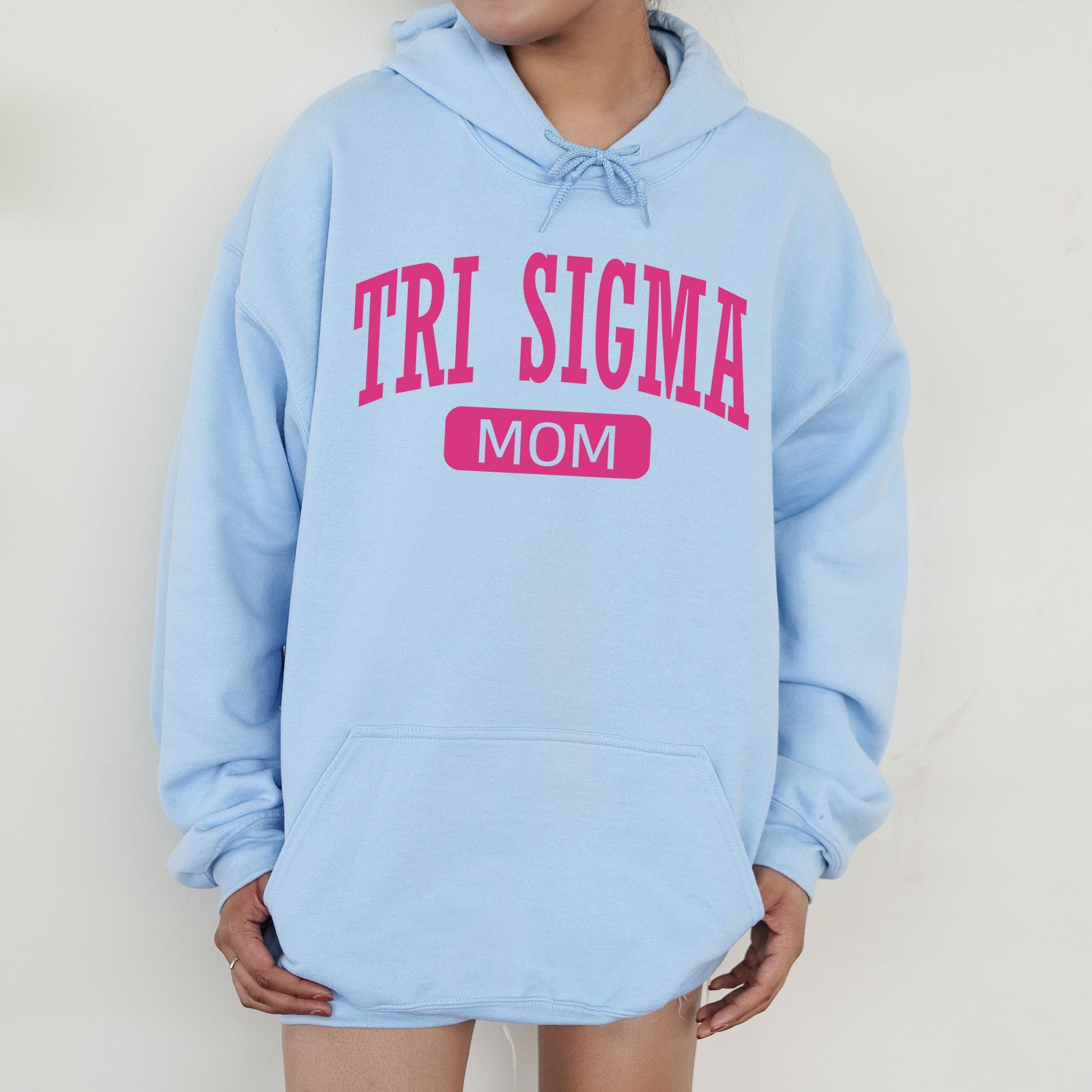 a woman wearing a blue sweatshirt with the word tri stigma on it