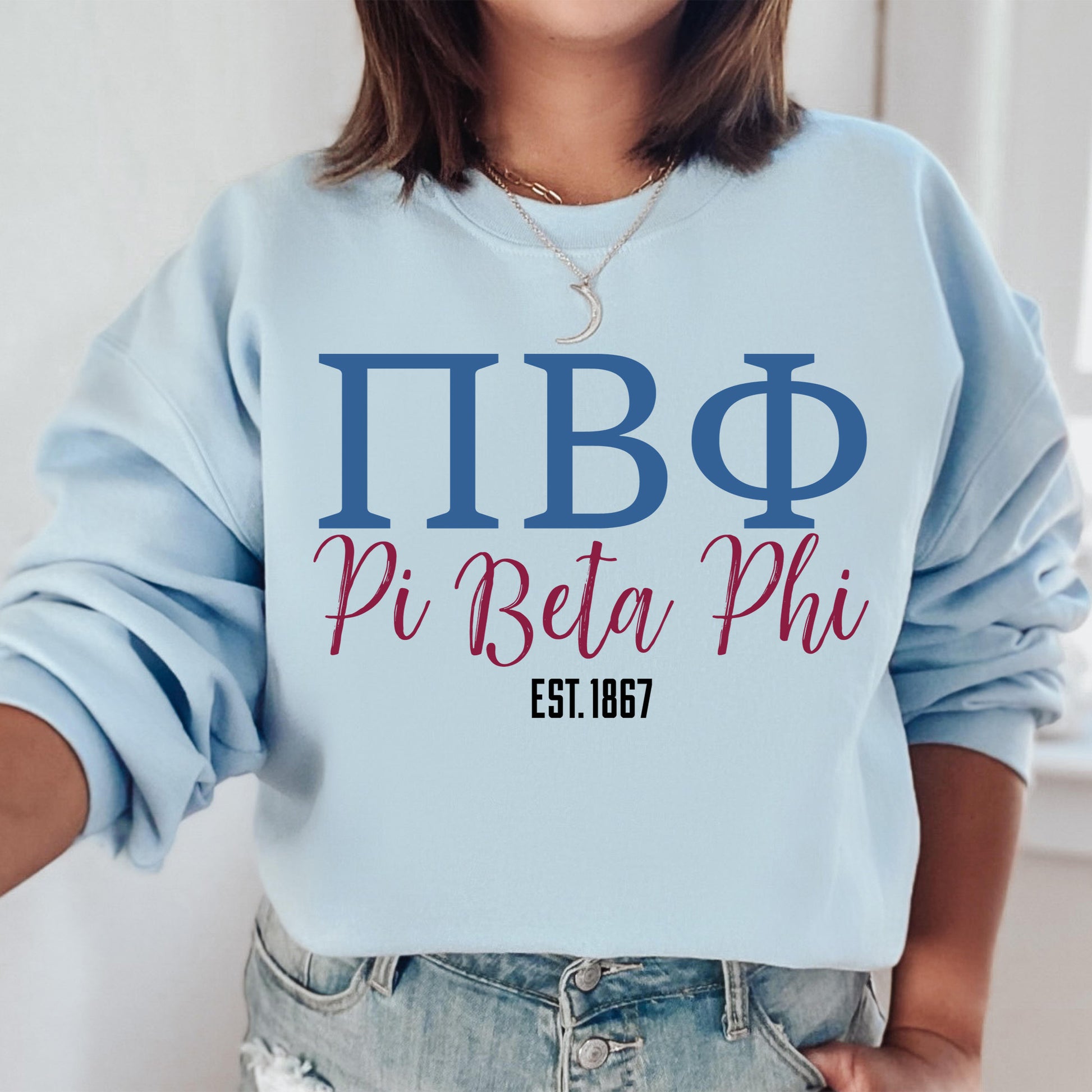 a woman wearing a sweatshirt that says pi beta phi