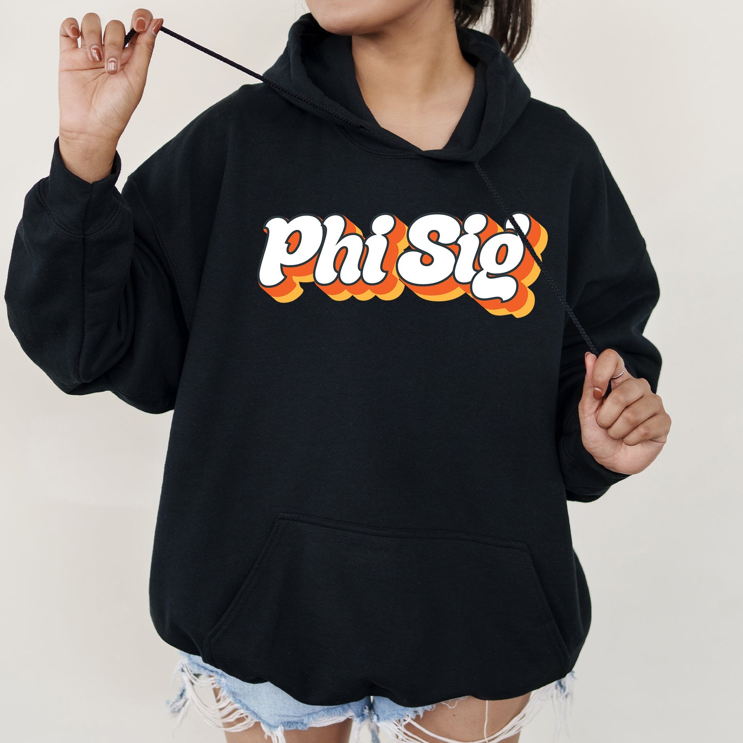 a woman wearing a black sweatshirt with the word phisig printed on it