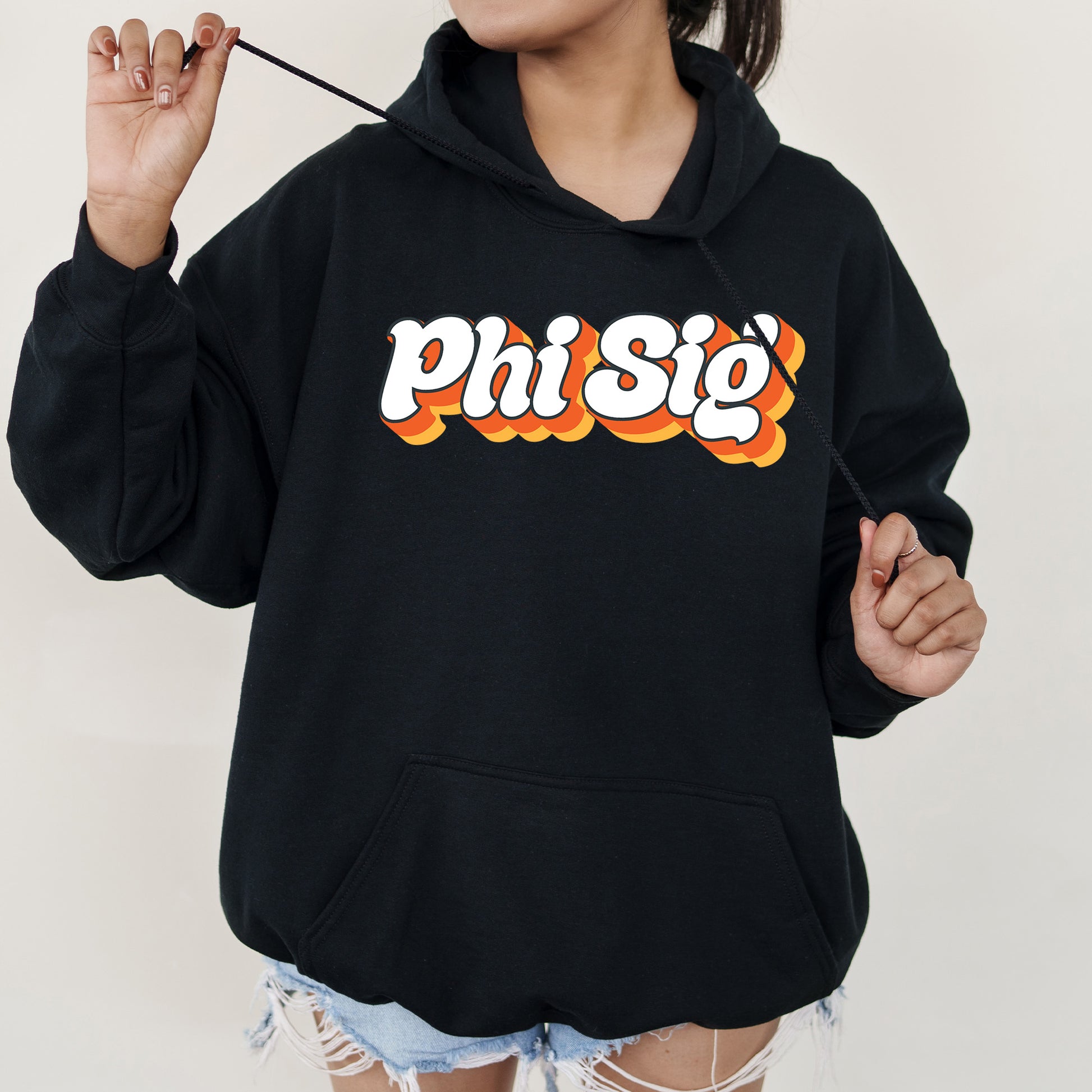 a woman wearing a black sweatshirt with the word phisig printed on it
