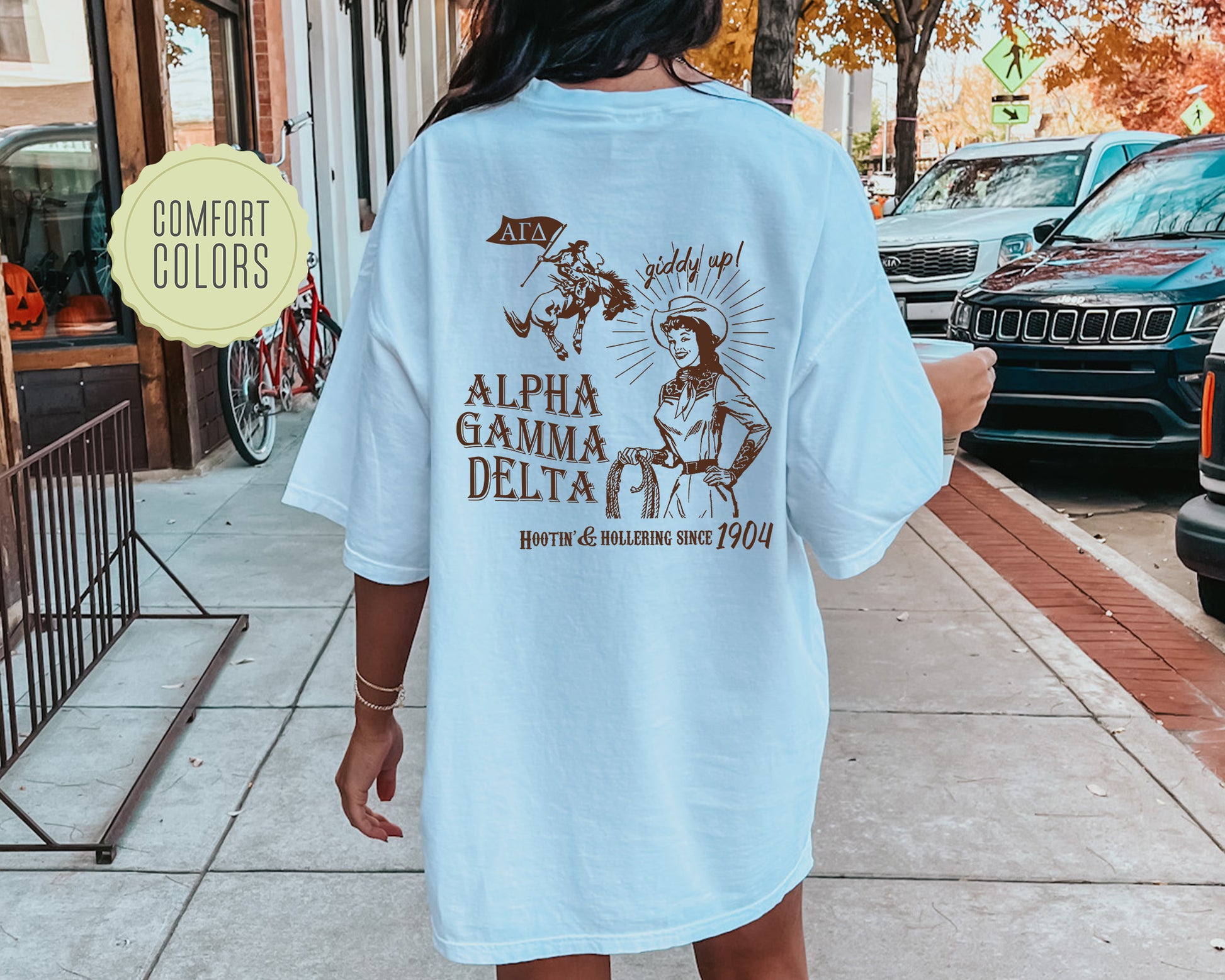 a woman walking down a sidewalk wearing a white shirt