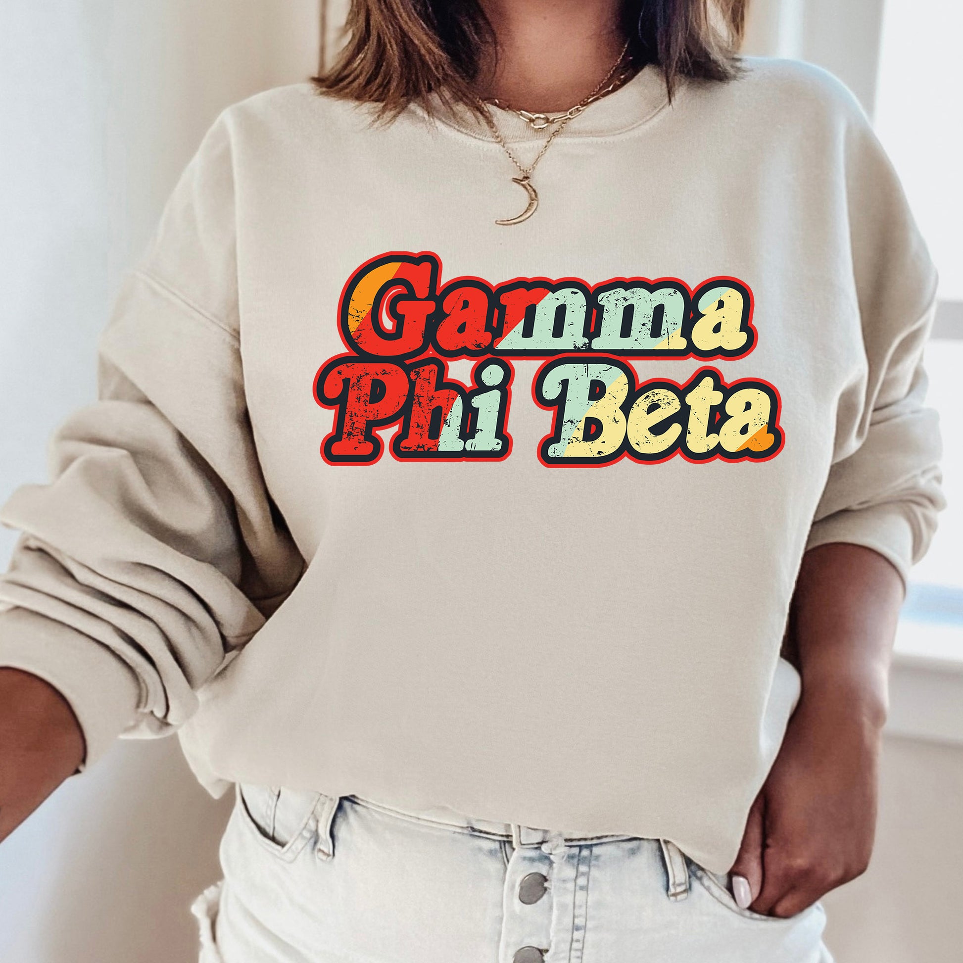 a woman wearing a sweatshirt that says gama phi beta