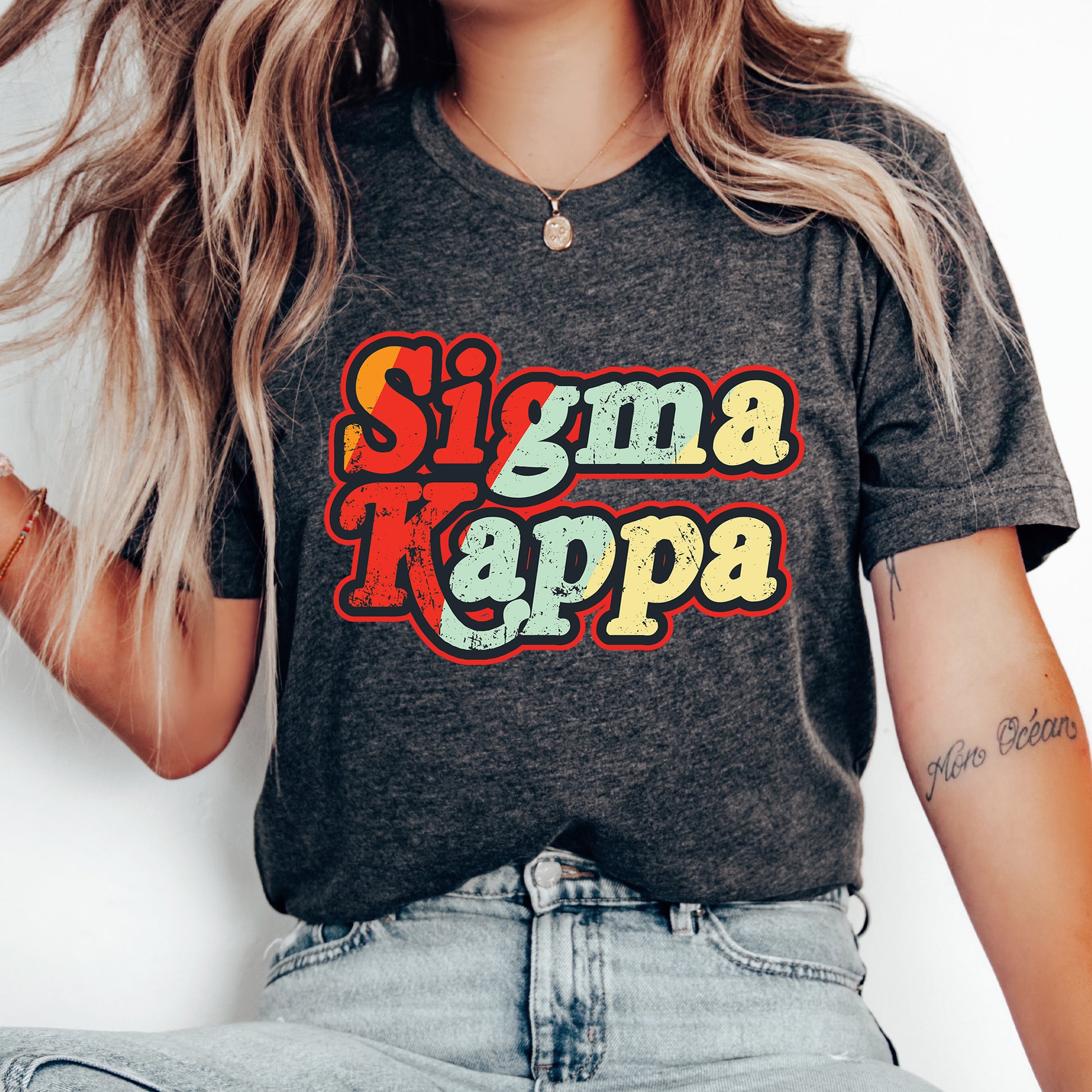 a woman wearing a shirt that says stigma kappa