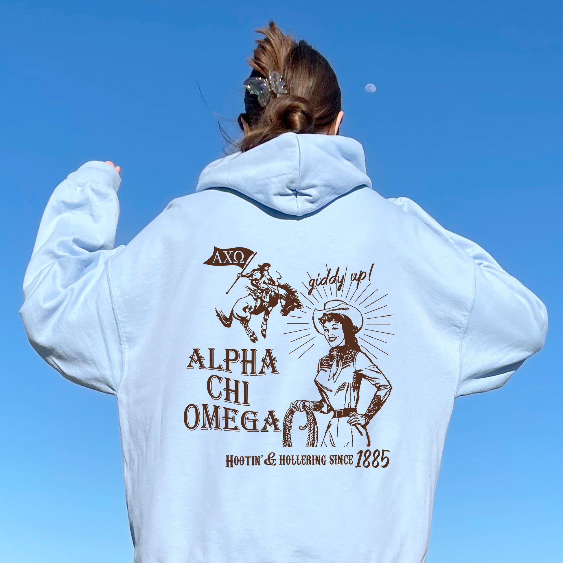 a woman wearing a white hoodie with an image of a woman on it