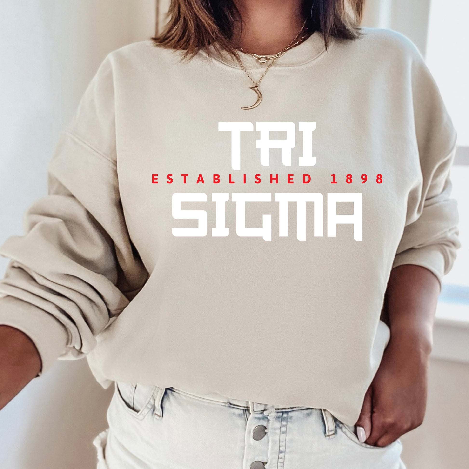 a woman wearing a sweatshirt that says tri established 1989