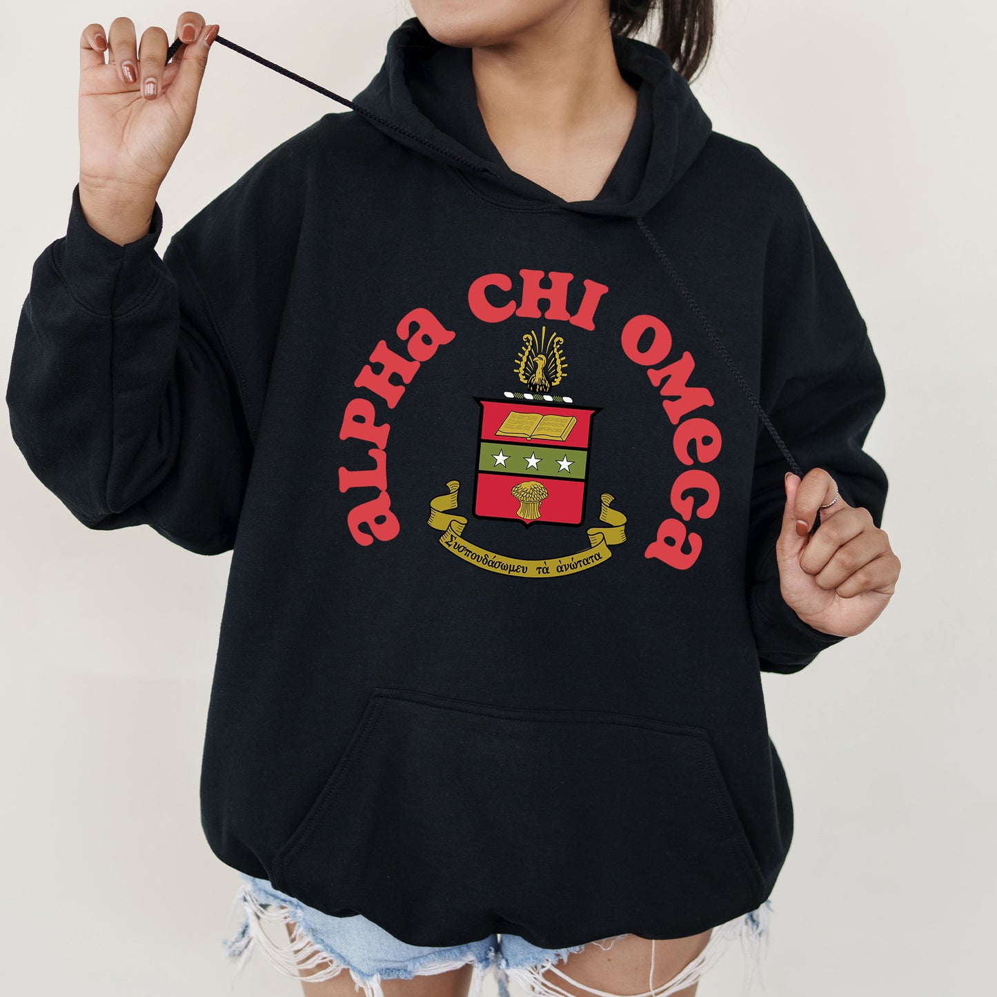 a girl in a black hoodie holding a toothbrush