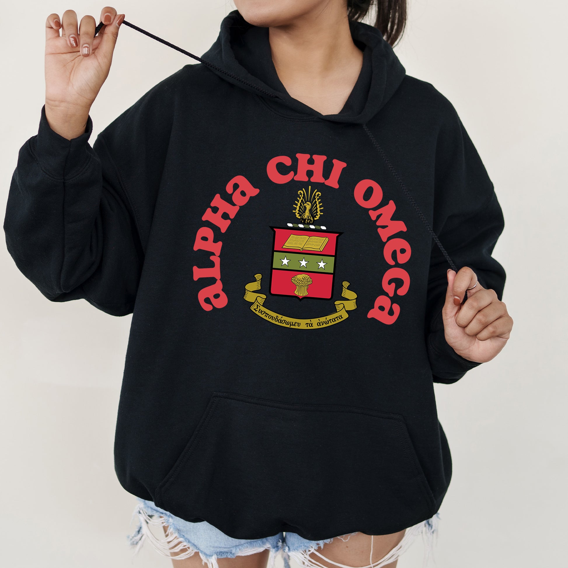 a girl in a black hoodie holding a toothbrush